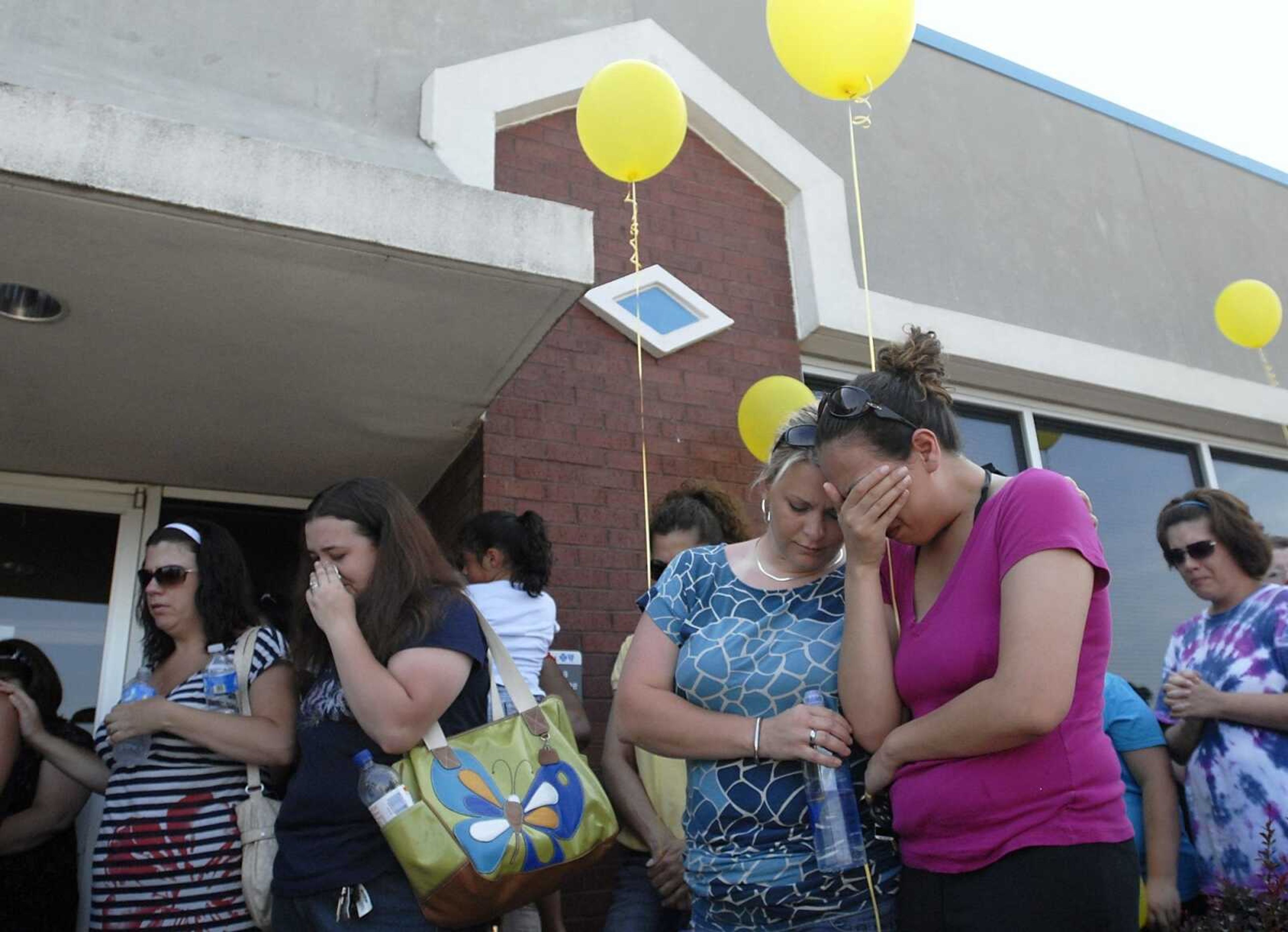 From left, Rachel Daley, Christy Gill, Deanna Sides and Jennifer Laird, attend a prayer service for Jacque Sue Waller at Anthem Blue Cross Blue Shield in Cape Girardeau on Saturday, June 4, 2011. Waller, a 39-year-old mother of three, has been missing since Wednesday. (Kristin Eberts)