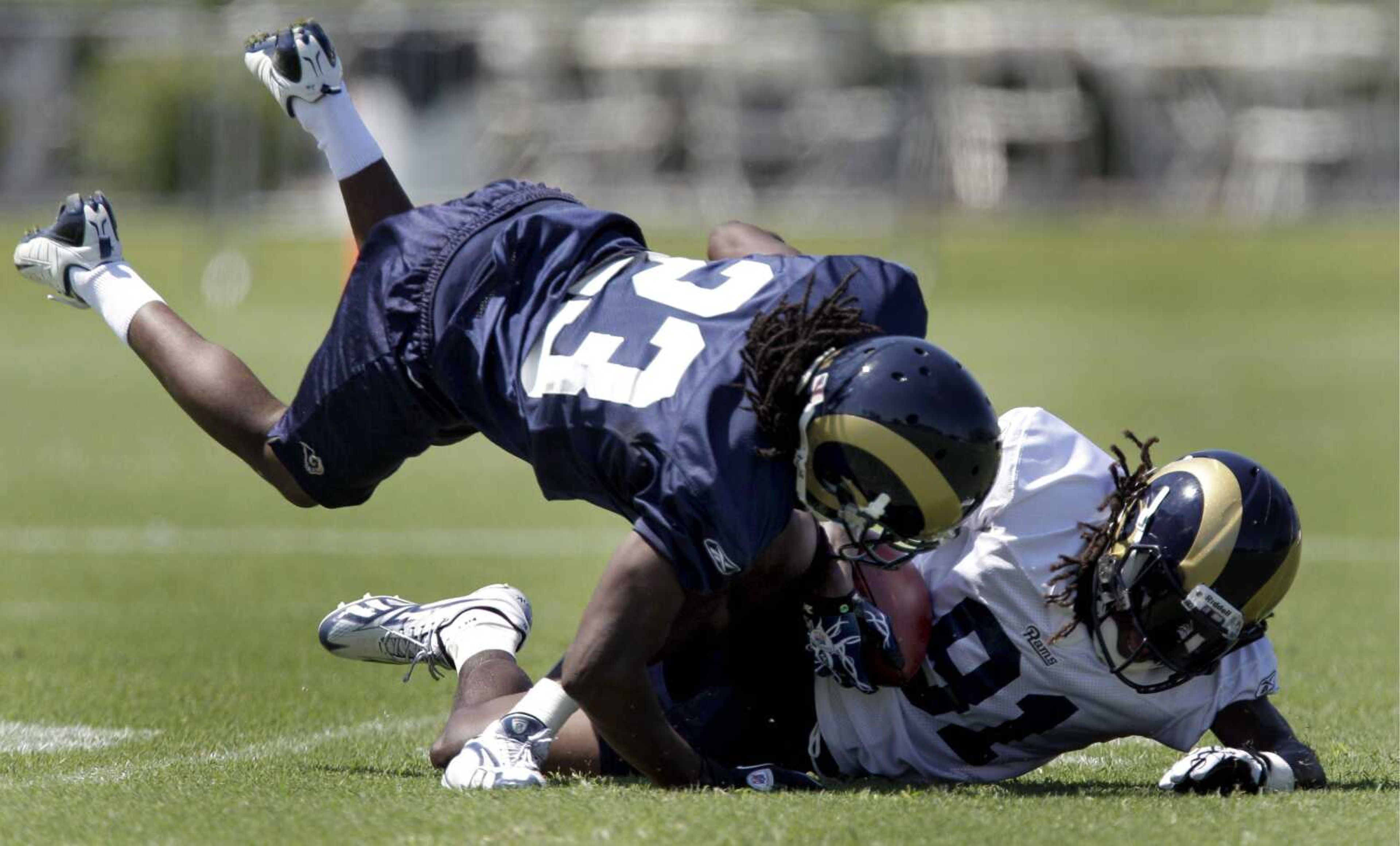 Rams wide receiver Mardy Gilyard, right, hauls in a pass as cornerback Jerome Murphy defends during training camp last month in St. Louis. (JEFF ROBERSON ~ Associated Press)