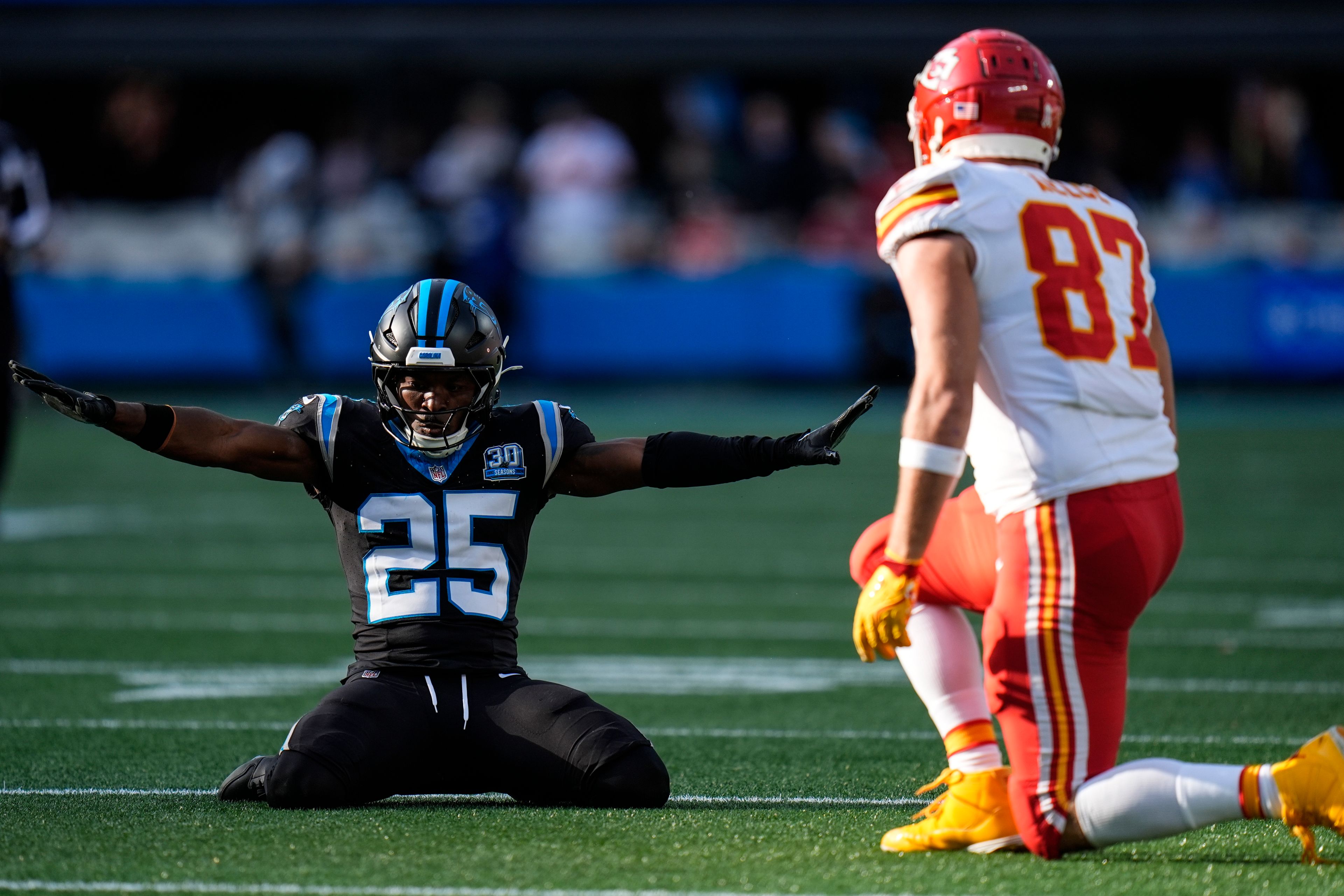 Carolina Panthers safety Xavier Woods (25) celebrates breaking up a pass intended for Kansas City Chiefs tight end Travis Kelce (87) during the second half of an NFL football game, Sunday, Nov. 24, 2024, in Charlotte, N.C. (AP Photo/Rusty Jones)