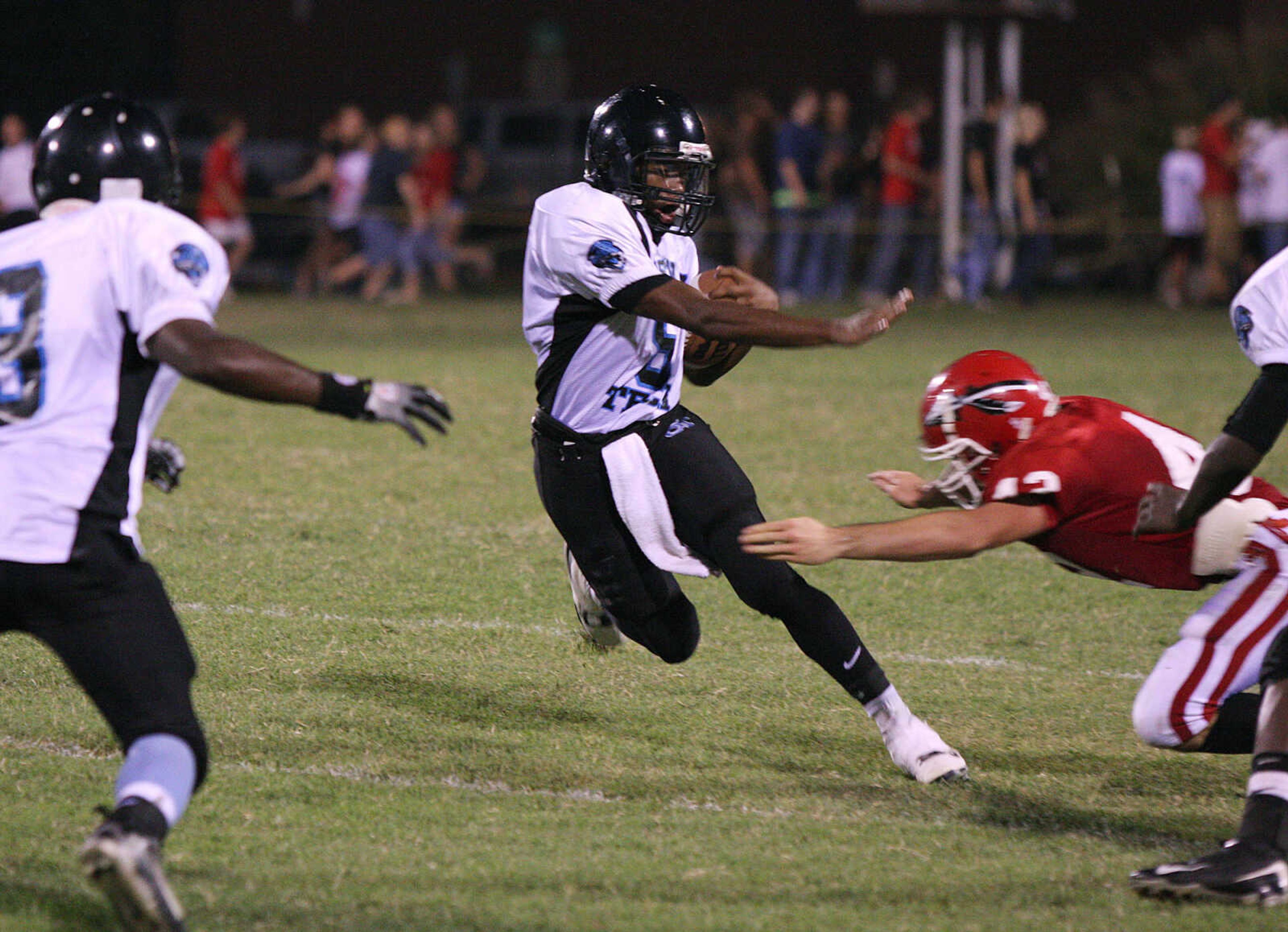 Gateway Tech's Paul Rice, center, trys to stiff arm Jackson's Ryan Marble as he moves downfield with the ball.