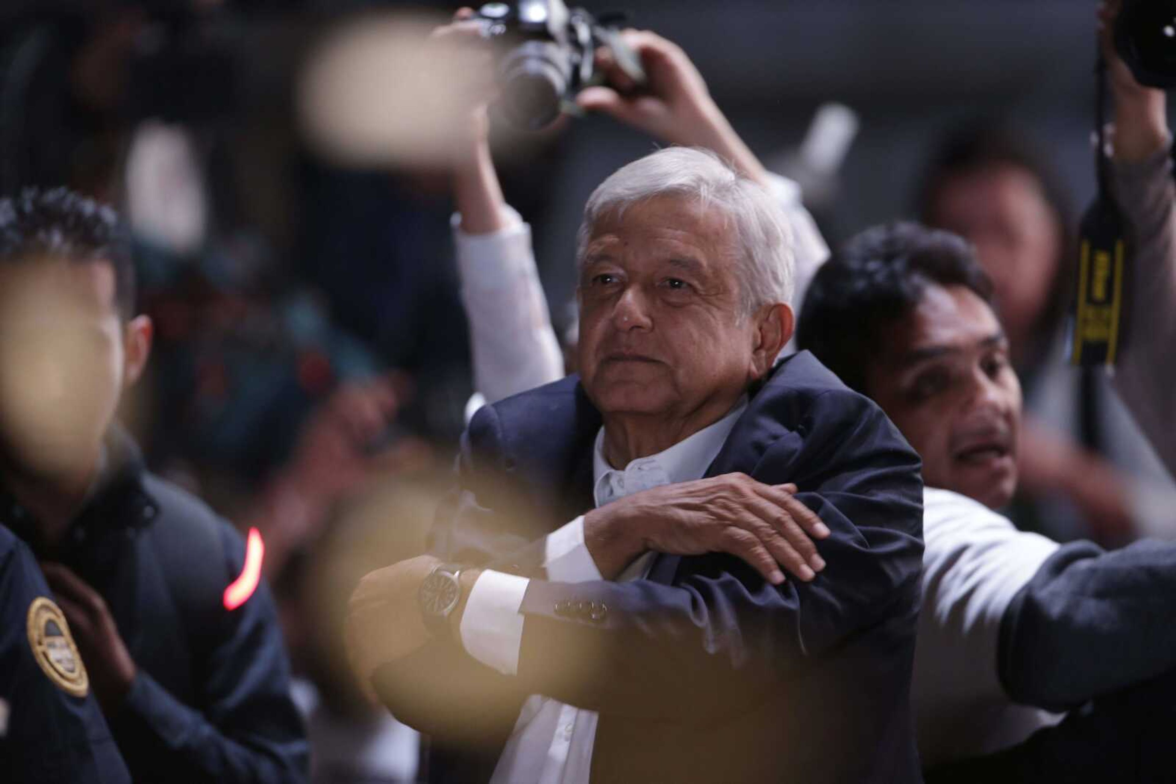 Presidential candidate Andres Manuel Lopez Obrador acknowledges his supporters as he arrives to Mexico City's main square, the Zocalo, Sunday. Lopez Obrador has claimed victory in Mexico's presidential election, calling for reconciliation.