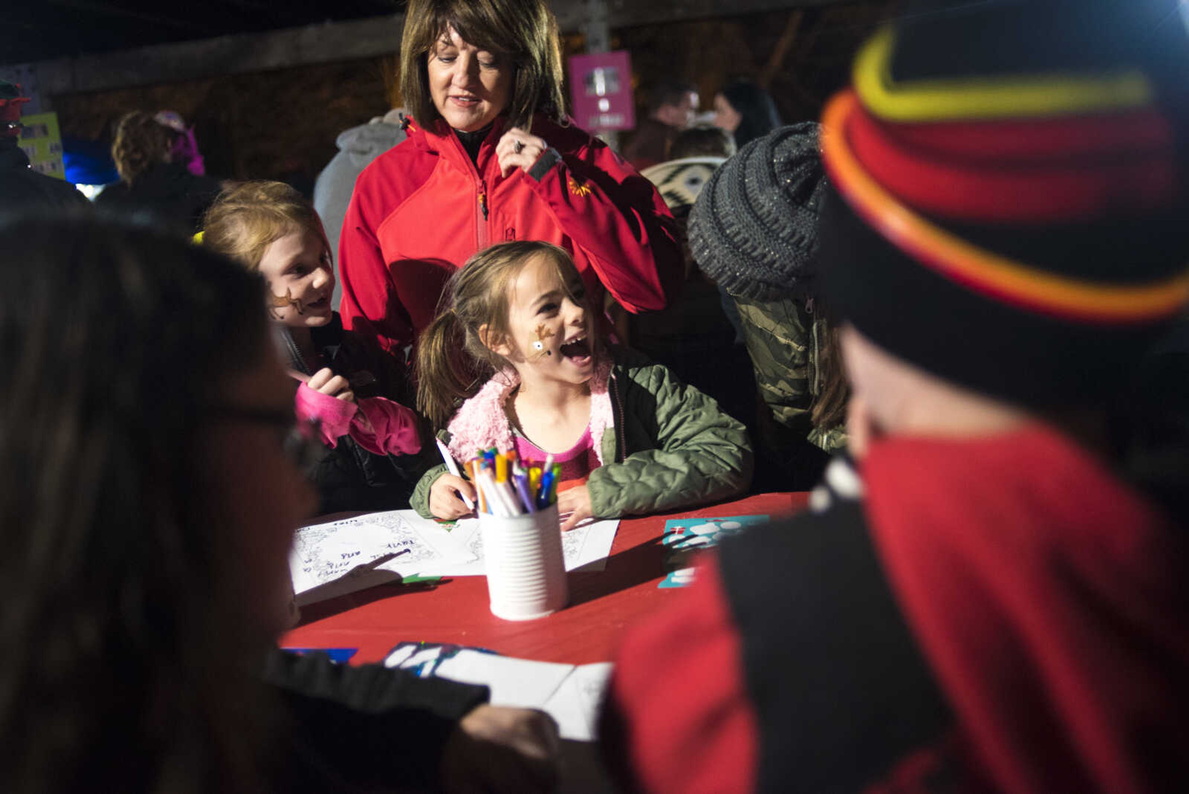 McCartney Ogle, 6, and Liley Dawes, 6, write letters to Santa during the Jackson Holiday Extravaganza Friday, Nov. 24, 2017 at the Jackson City Park.