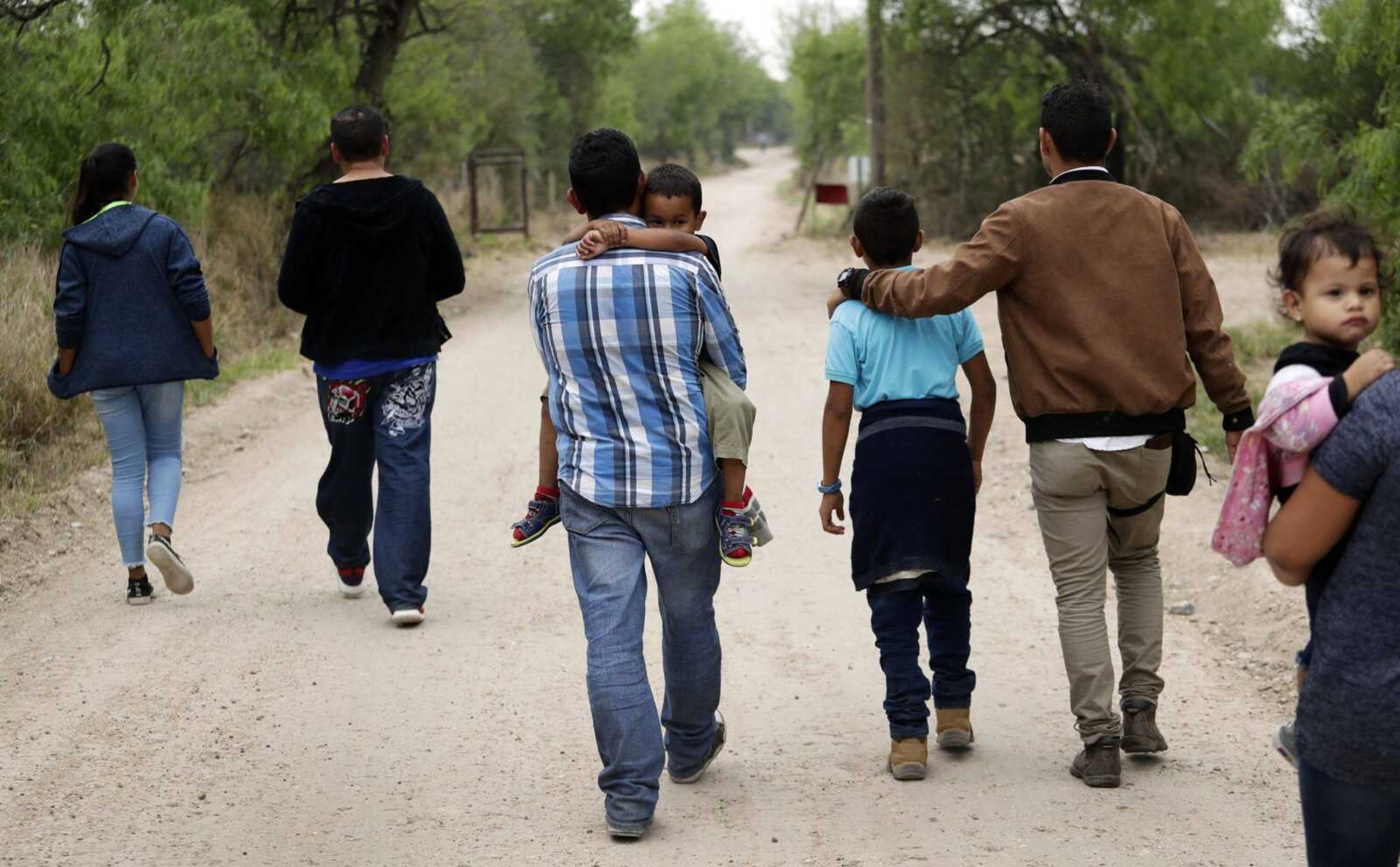 A group of migrant families walk from the Rio Grande near McAllen, Texas, right before being apprehended by Border Patrol in March.