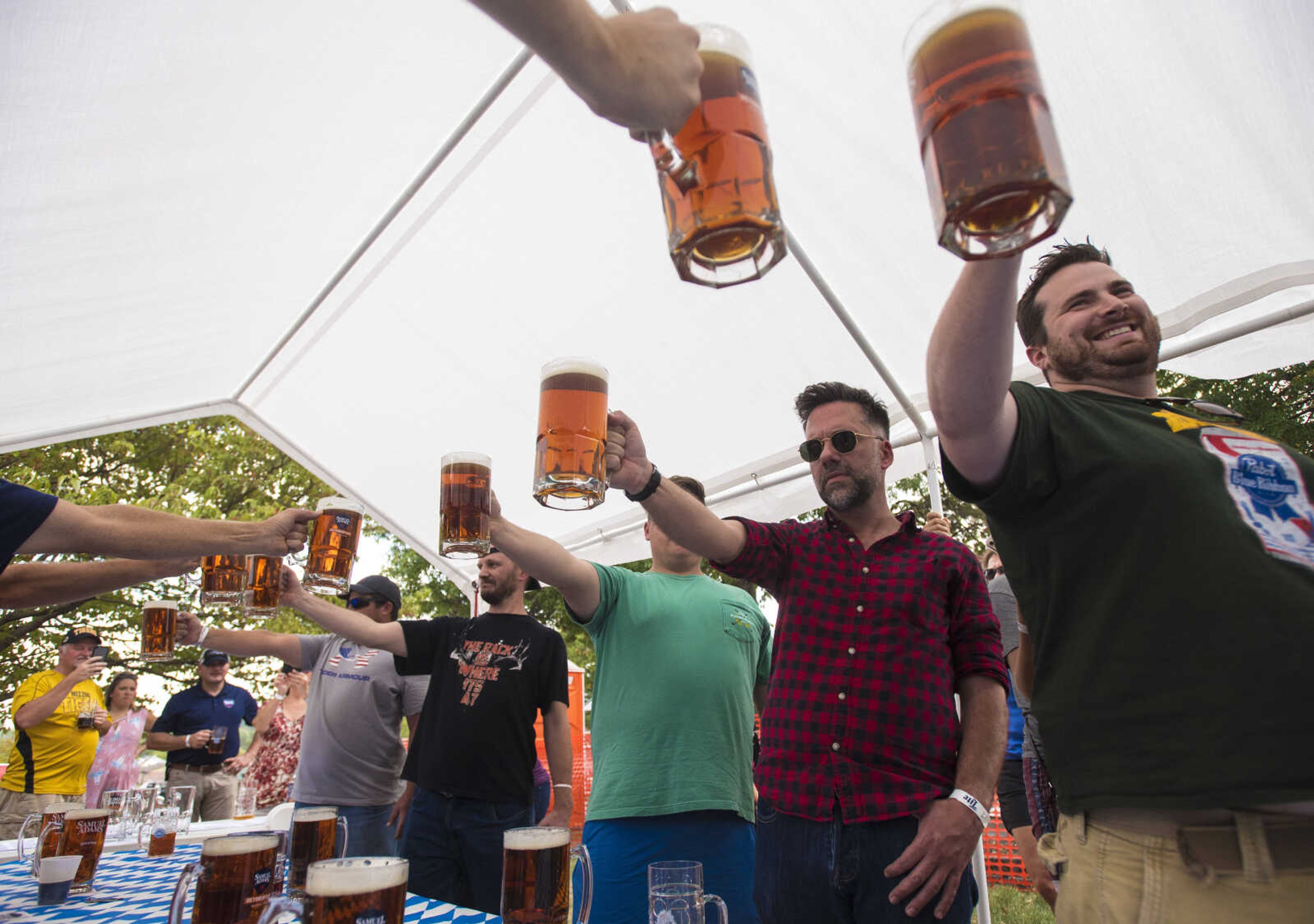 People compete in the Sam Adams Stein Hoisting at the Uptown Jackson Oktoberfest, Saturday, October 7, 2017.