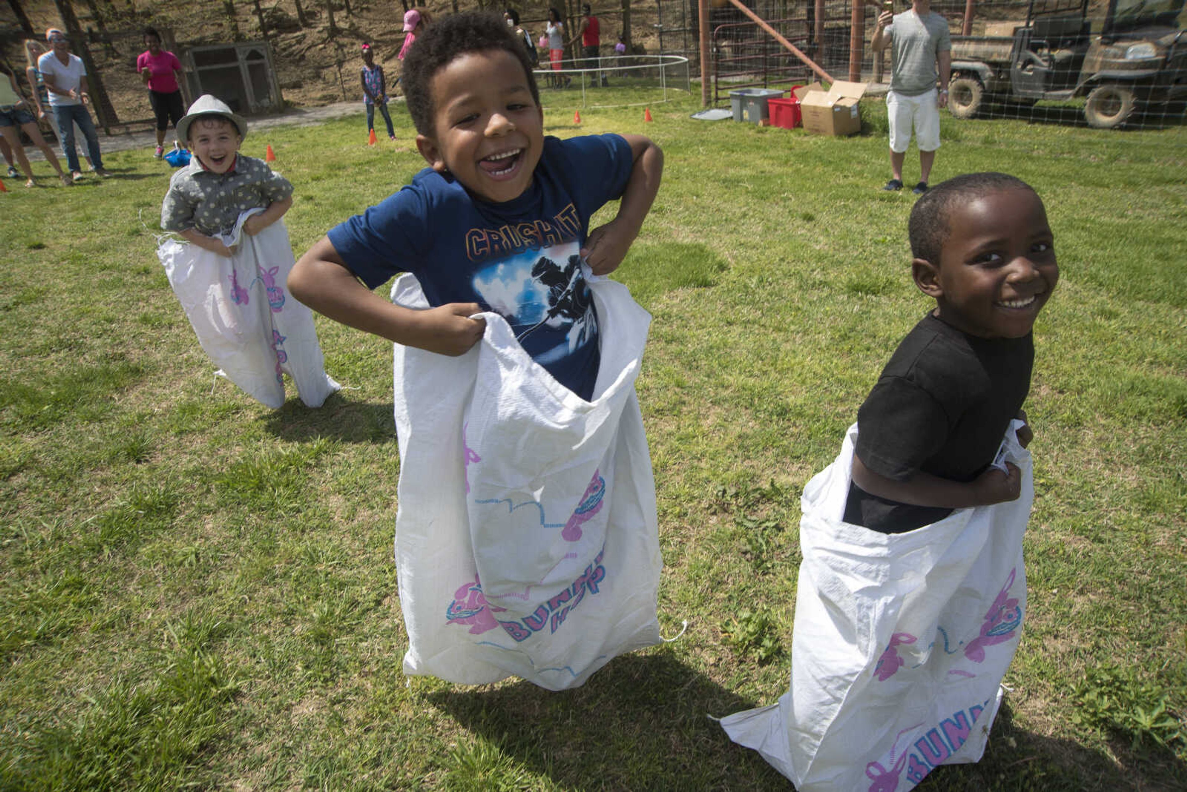 From left, Liam McGill, 4, Kyron Redd, 5, and RJ Fountain, 4, compete in the sack race during the Safari Egg Hunt Saturday, April 15, 2017 at Lazy L Safari Park in Cape Girardeau.