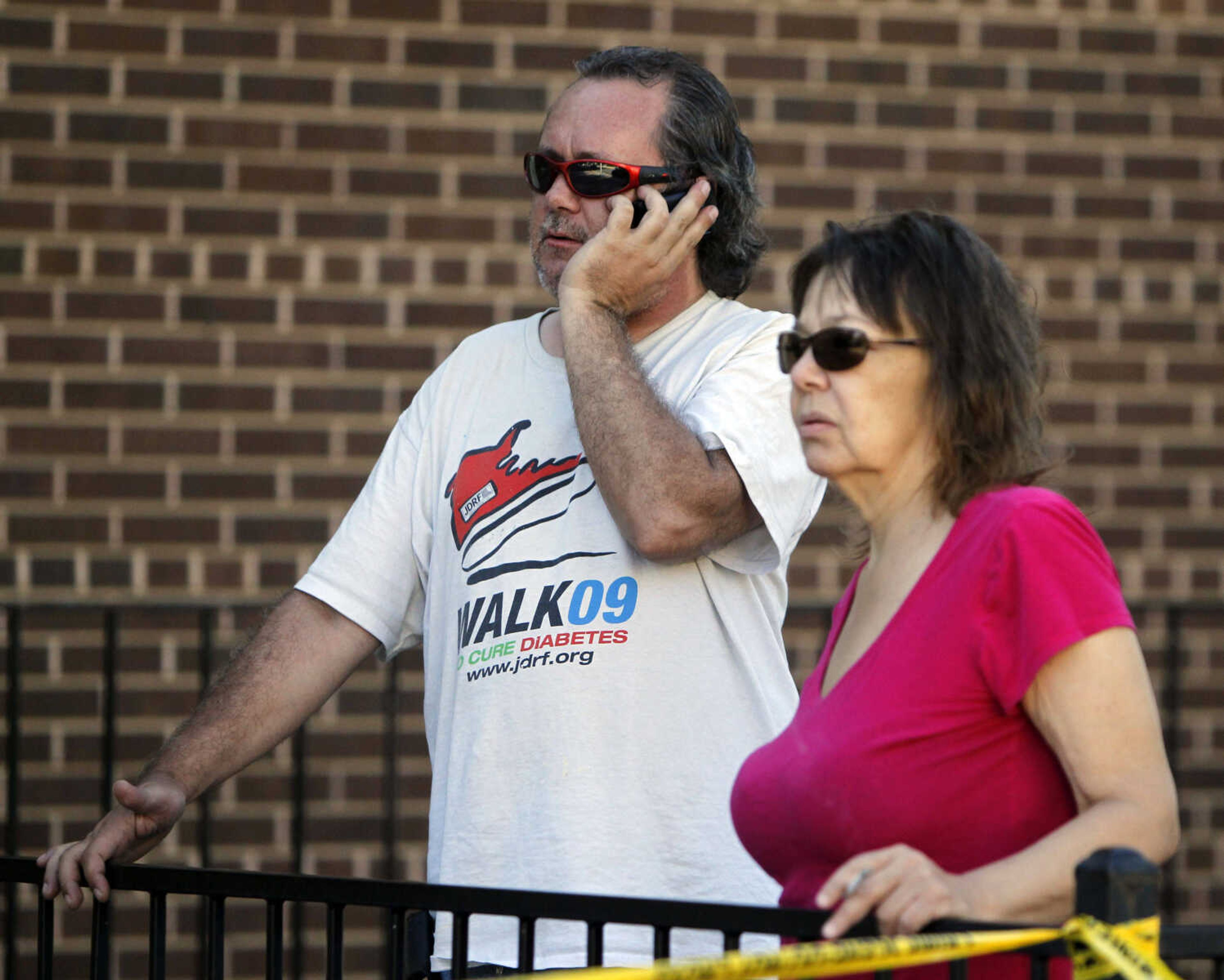 John Priest, left, and Vory Boots watch the police action at an apartment where the suspect in a theatre shooting lived in Aurora, Colo., on Friday, July 20, 2012. The couple were evacuated from their apartment across from the suspects.  As many as 12 people were killed and 50 injured at a shooting at the Century 16 movie theatre on Friday. The suspect is identified as 24-year-old James Holmes.  (AP Photo/Ed Andrieski)