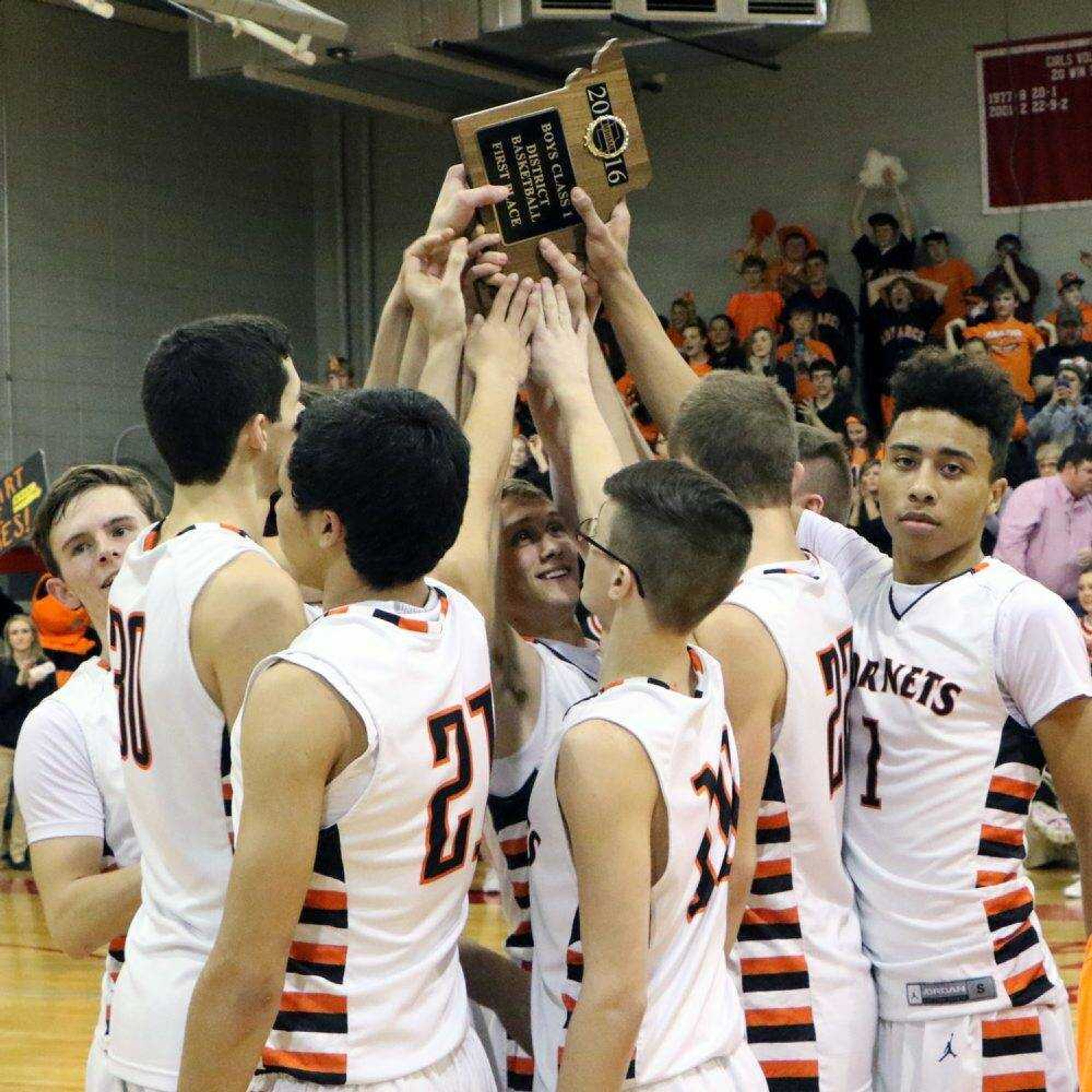 Advance players hold up the Class 1 District 2 championship plaque after beating Oran 88-70 in the title game Thursday night at Richland High School in Essex, Missouri.