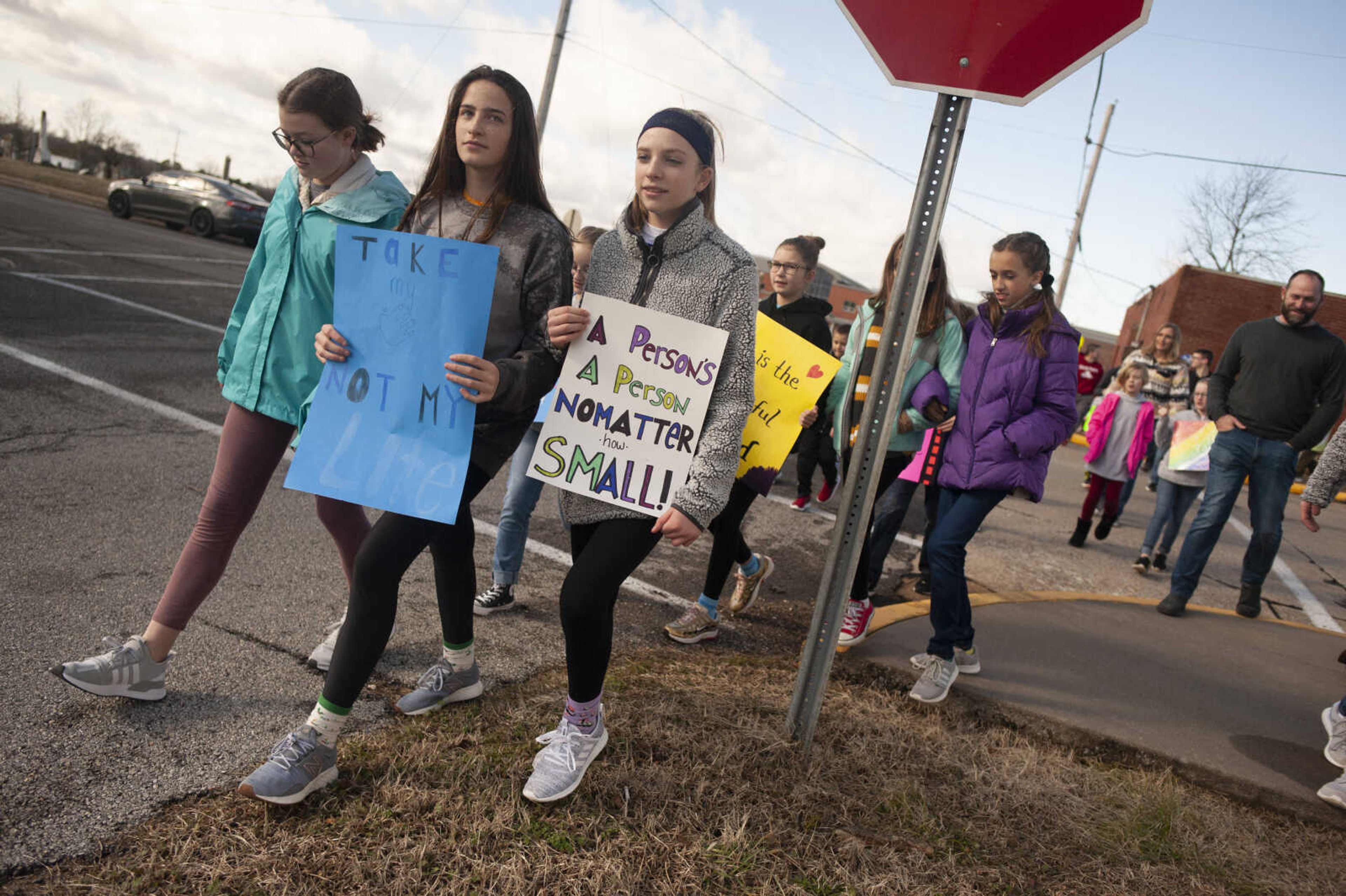 Front row from left: Erica DeBrock, 14, of Jackson, Adyson Seabaugh, 12, of Cape Girardeau, and Aubrey Keran, 13, of Jackson, take part in a March for Life on Saturday, Jan. 18, 2020, in Jackson. Meg Garner, director of youth and family ministry at Immaculate Conception Catholic Church, said there is a national pro-life march in Washington, D.C., and many can't make it there, so the decision was made to do their own "mini march." Garner said she and students with the pro-life group "Students4Life" at Immaculate Conception School coordinated the event. Garner said it's important to "defend those who cannot defend themselves."