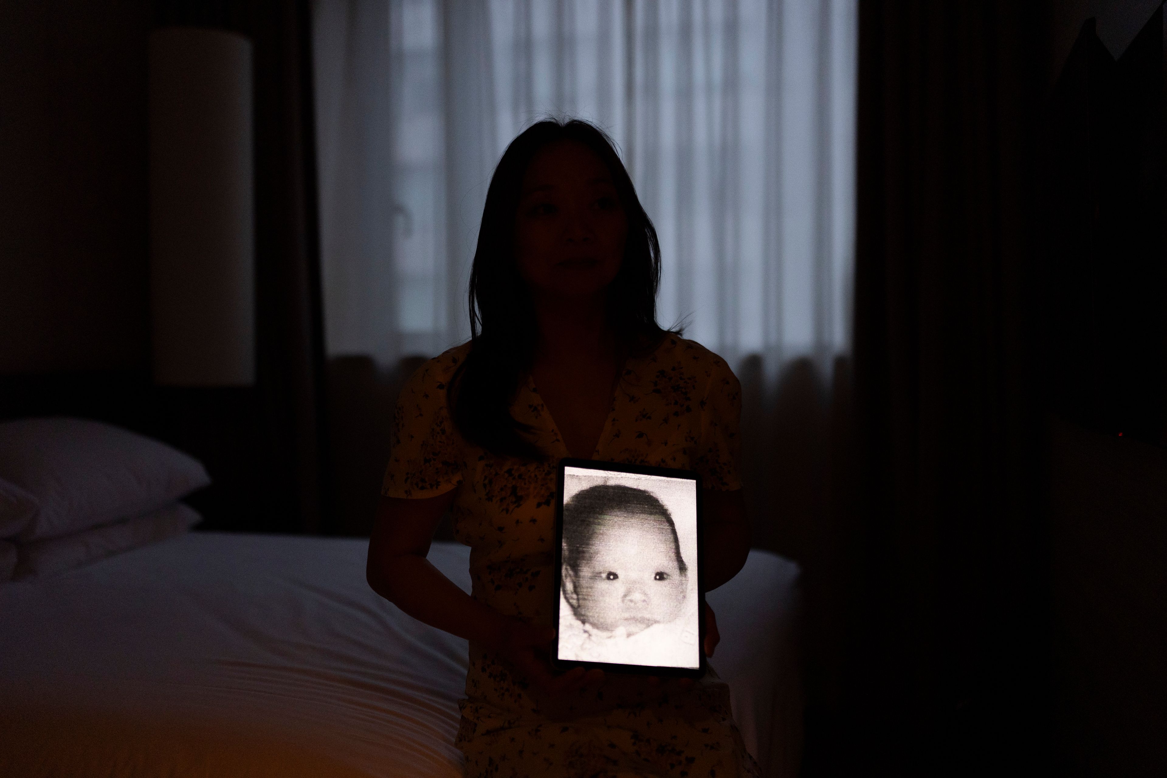 Maja Andersen sits for a photo in her hotel room, holding a tablet displaying her baby photo taken before her adoption to Denmark, as she visits Seoul, South Korea to search for her birth family, Monday, May 20, 2024. Andersen is among thousands of Korean adoptees who have taken a pilgrimage to their motherland for an emotional, often frustrating, sometimes devastating search for their origin story. (AP Photo/Jae C. Hong)