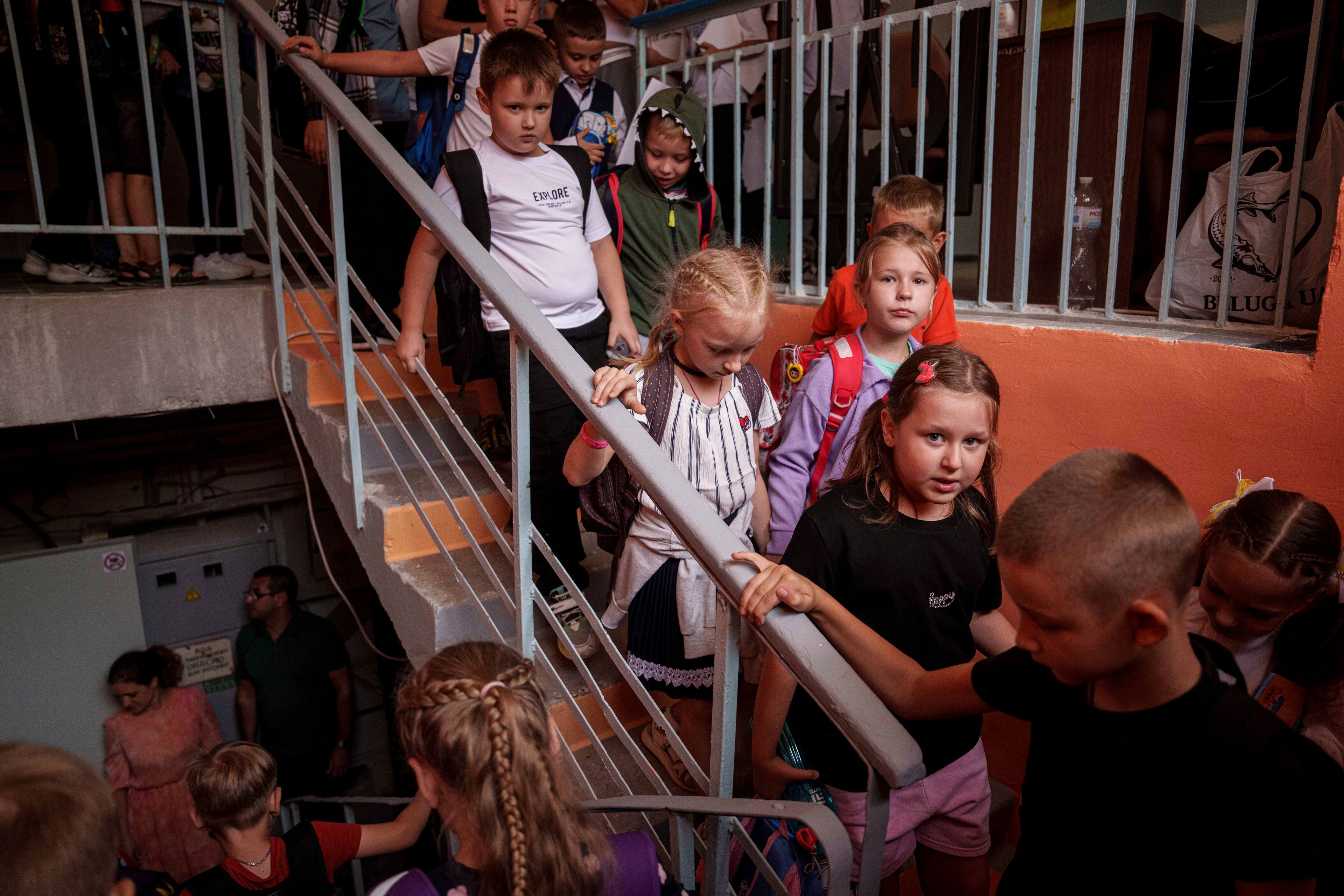 Children from Gymnasium No. 6 head to a basement set up with classrooms during an air alert in Zaporizhzhia, Ukraine, Sept. 3, 2024. The city is building a dozen subterranean schools designed to be radiation- and bomb-proof. (AP Photo/Evgeniy Maloletka)