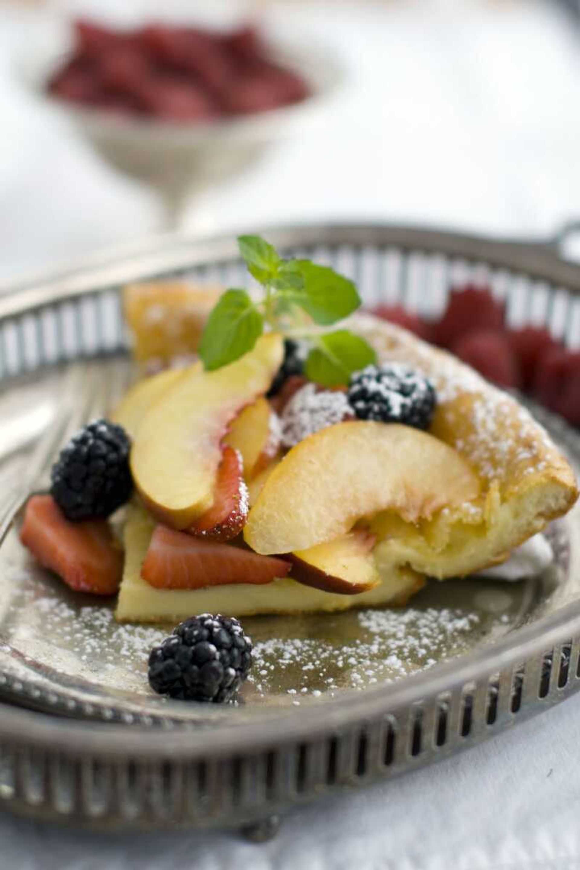 This March 21, 2011 photo shows a fruit bismarck in Concord, N.H. Bismarcks are also known as Dutch babies and German pancakes. Though this oven pancake isn't commonly served as a breakfast item in England, its savory counterpart, known as Yorkshire pudding, is served for Sunday dinner with leftovers being served with jam for dessert. (AP Photo/Matthew Mead)