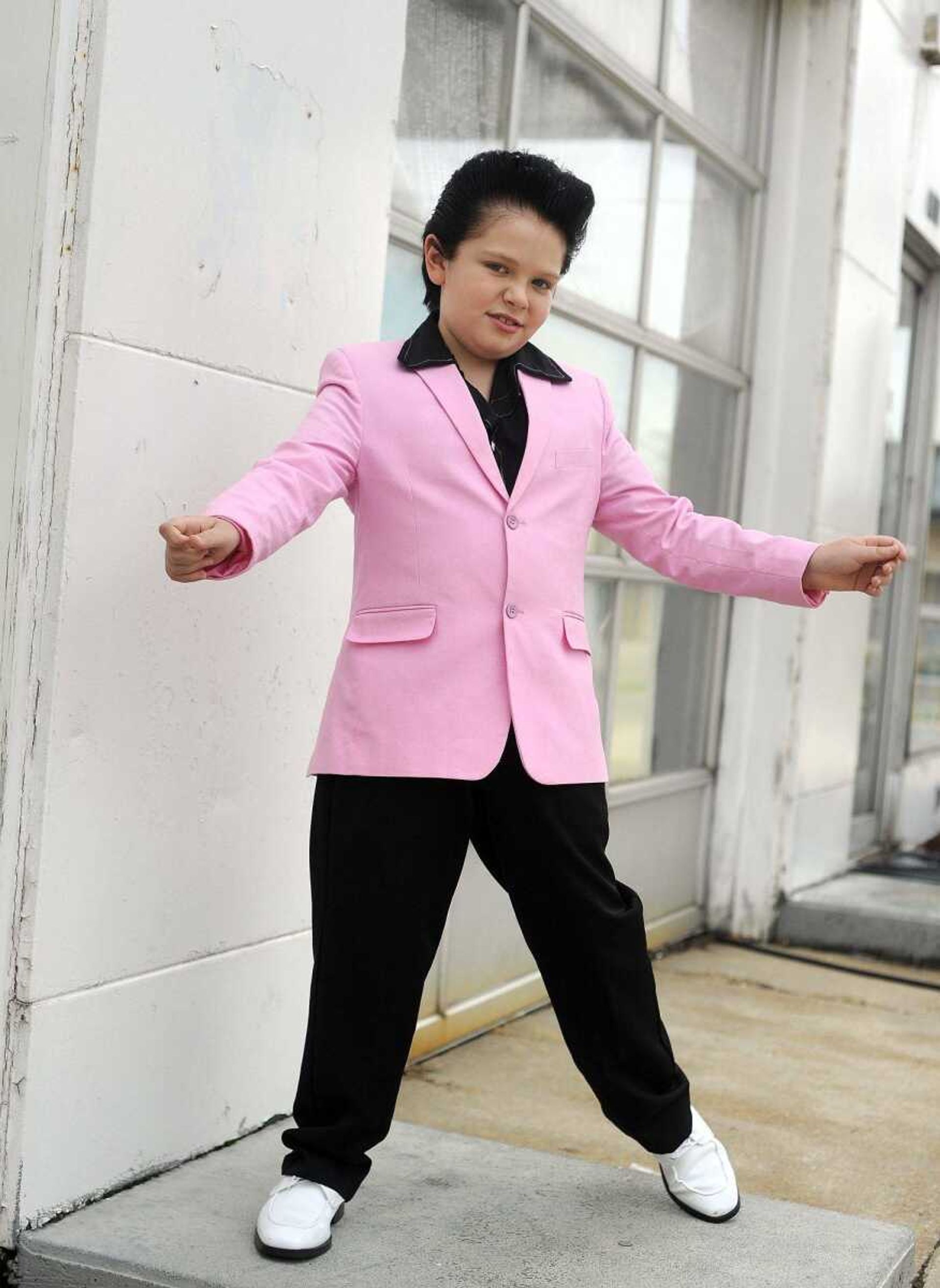 Finley Watkins, 8, poses for photos as Elvis on Tuesday, Aug. 16, 2016, in Dexter, Missouri. Watkins has been performing as Elvis since he was five years old.