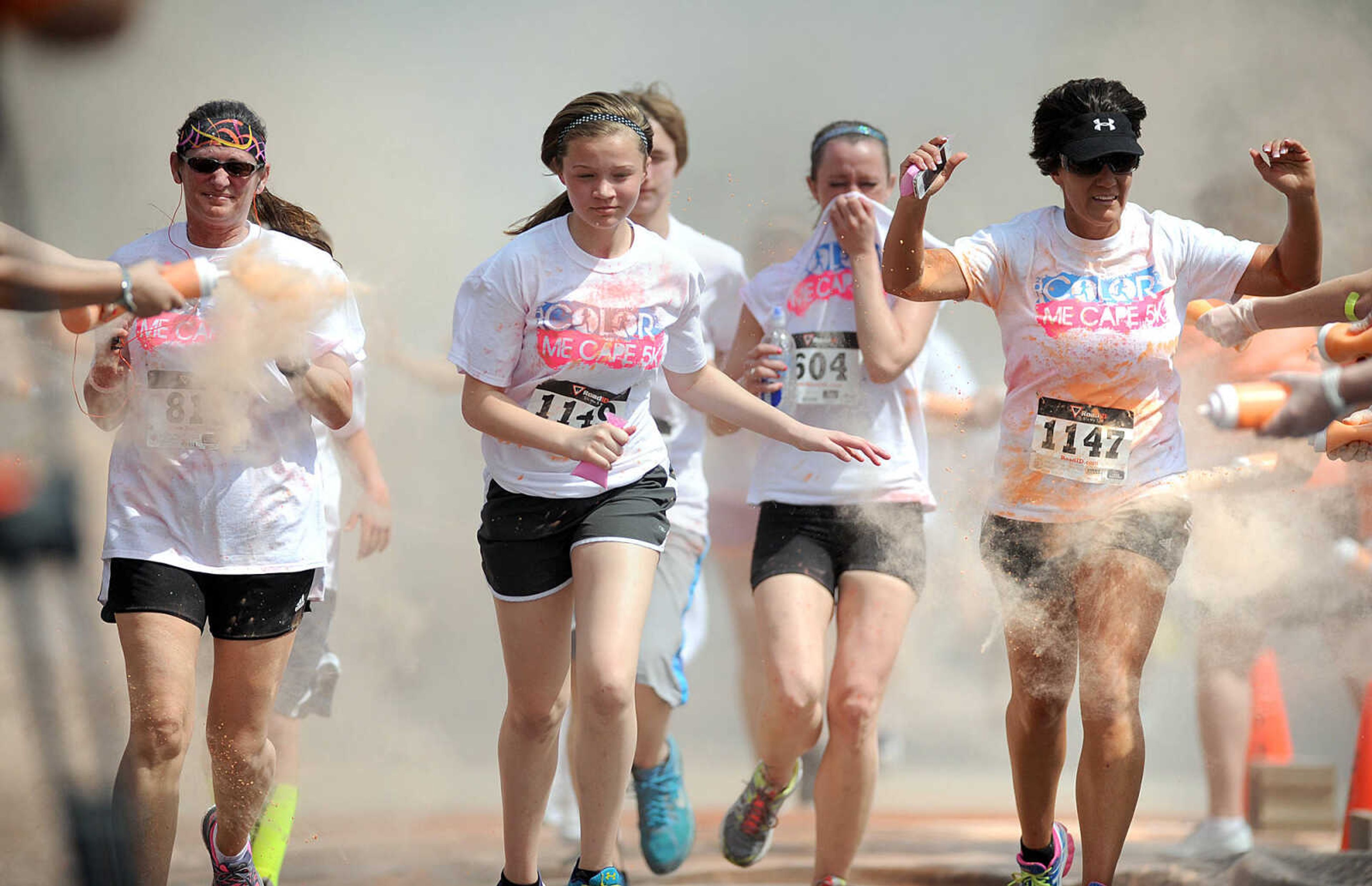 LAURA SIMON ~ lsimon@semissourian.com

Participants in the Color Me Cape 5K are sprayed with orange powder at the first color station on Good Hope Street, Saturday, April 12, 2014, in Cape Girardeau.