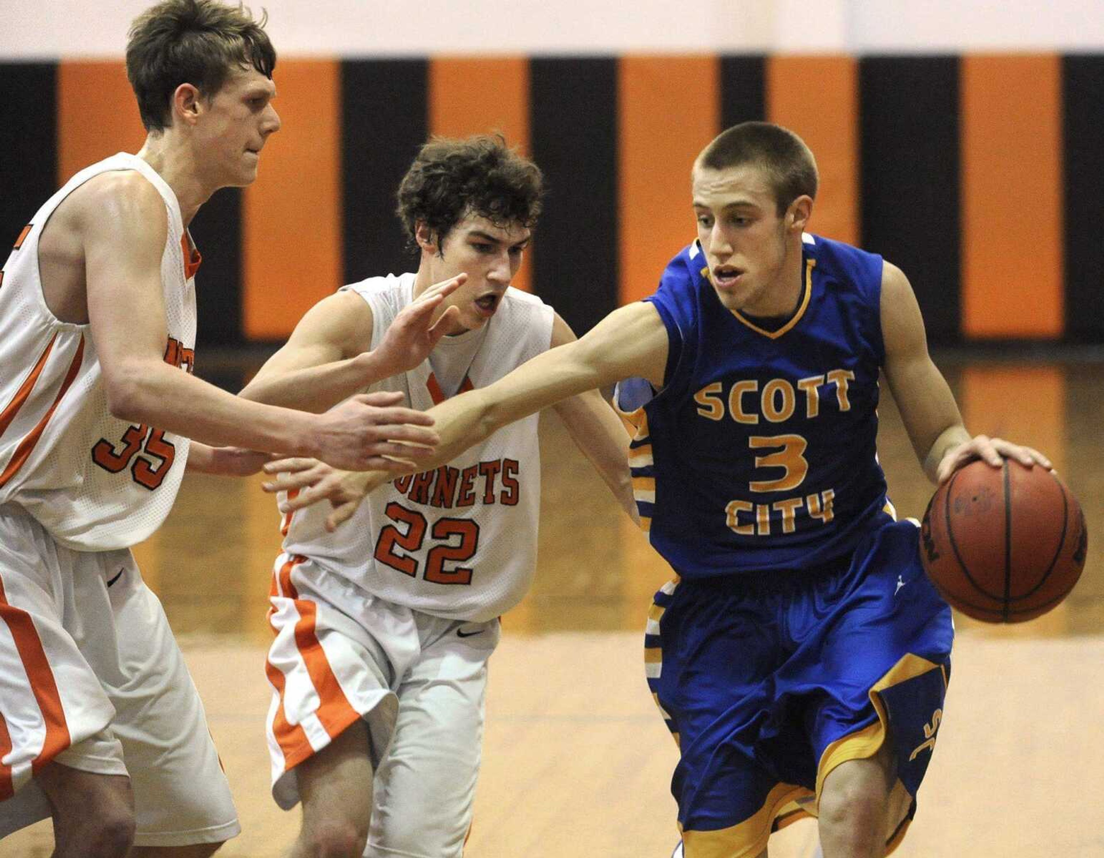 Scott City's Landon Robert drives against Advance's Curtis Gilliland, left, and Hunter Wilson during the fourth quarter Friday.