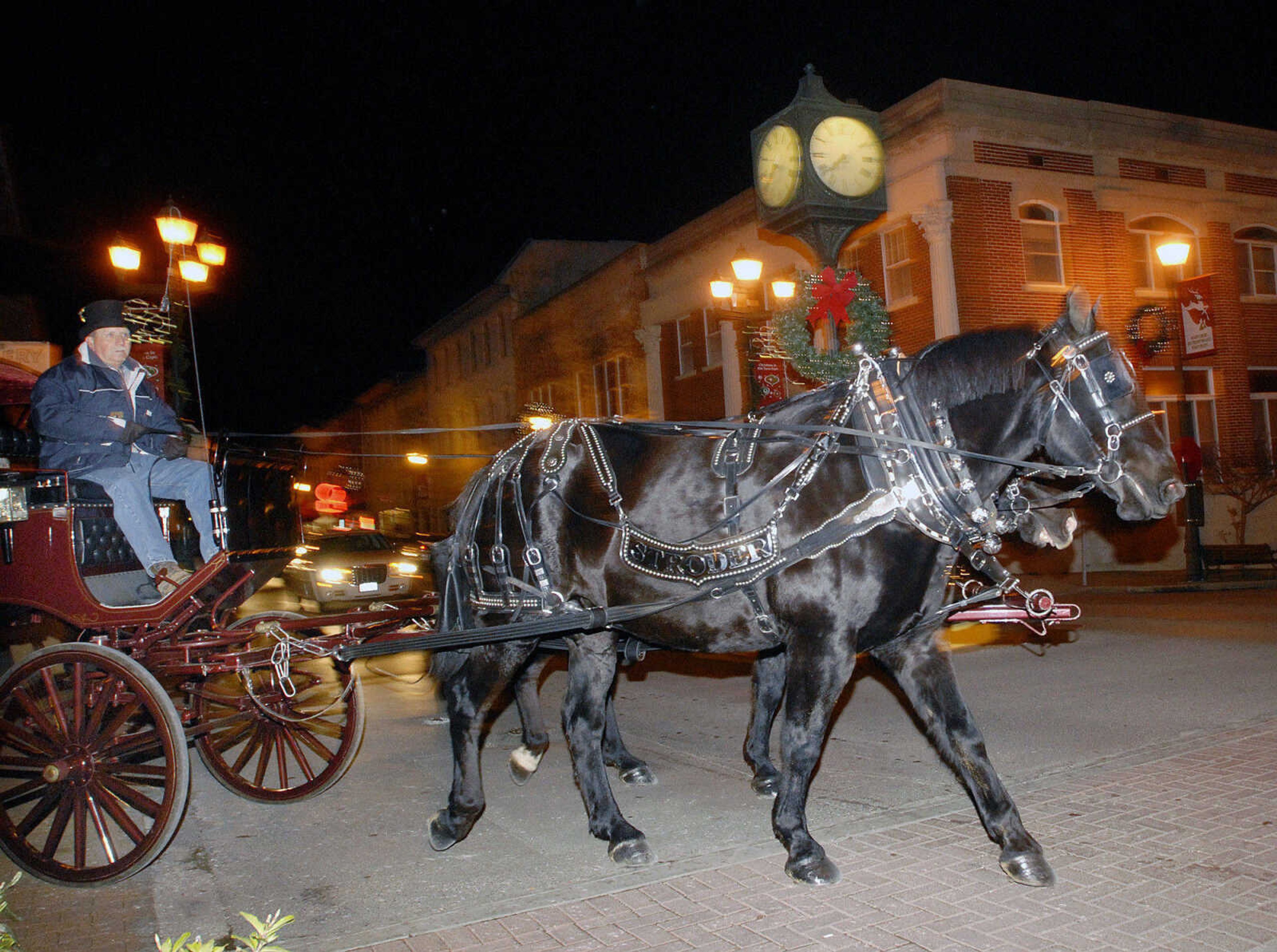 LAURA SIMON ~ lsimon@semissourian.com
Steve Stroder takes people for a carriage ride along Main Street Friday, Dec. 2, 2011 during Old Town Cape's annual Downtown Christmas Open House.