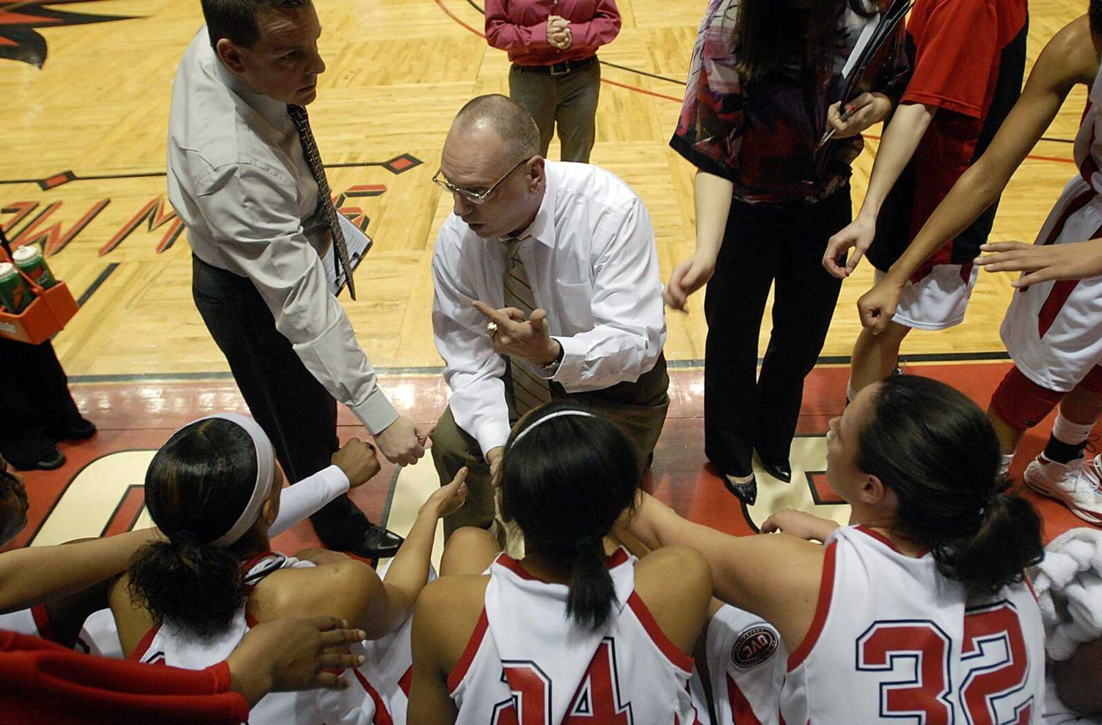 KIT DOYLE ~ kdoyle@semissourian.com
Southeast Missouri coach John Ishee, center, and assistant Chris Harris huddle with the players during a January game at the Show Me Center. Ishee was injured in a car accident Sunday and still will be hospitalized for tonight's first-round OVC tournament game at Tennessee State. Harris will lead the Redhawks in Ishee's absence.