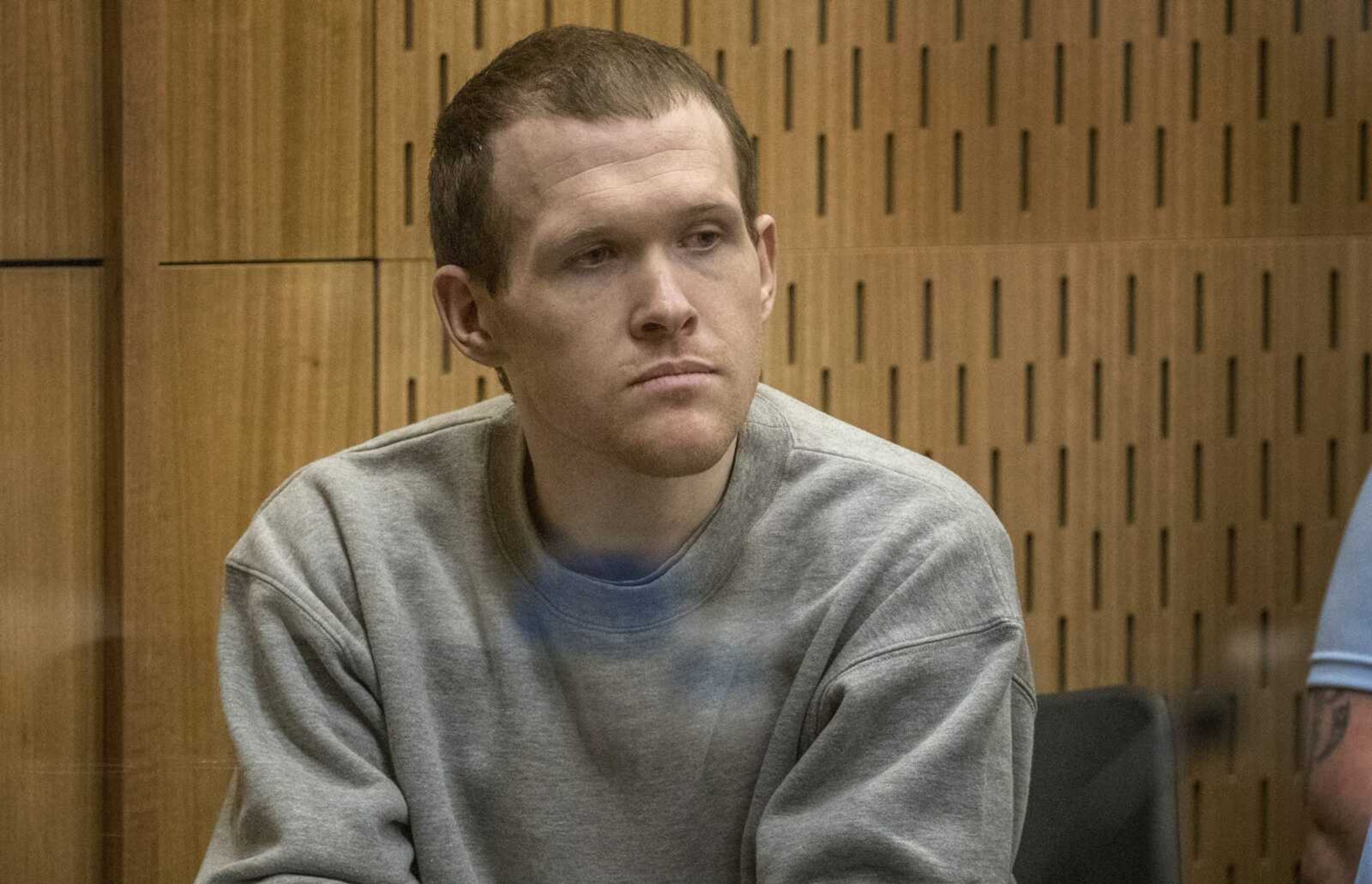 Twenty-nine-year-old Australian Brenton Harrison Tarrant sits in the dock at the Christchurch High Court for sentencing after pleading guilty to 51 counts of murder, 40 counts of attempted murder and one count of terrorism in Christchurch, New Zealand, Monday, Aug. 24, 2020. More than 60 survivors and family members will confront the New Zealand mosque gunman this week when he appears in court to be sentenced for his crimes in the worst atrocity in the nation's modern history. (John Kirk-Anderson/Pool Photo via AP)