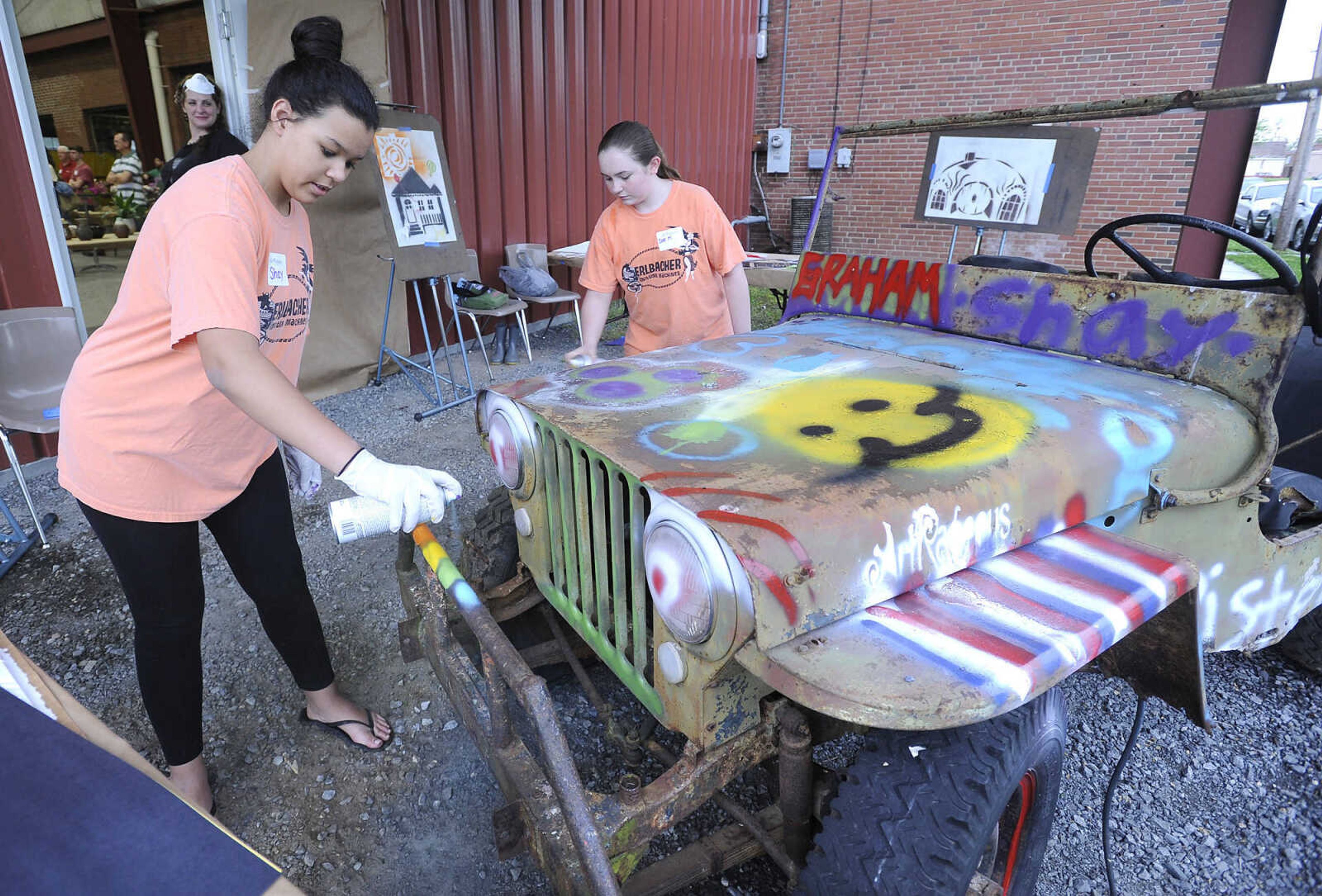 FRED LYNCH ~ flynch@semissourian.com
Shay Wiseman, left, and Zoe Mayfield spray-paint a Jeep with colorful expression Thursday, April 20, 2017 during ARTrageous at Erlbacher Gear and Machine Works in Cape Girardeau. The interactive art event kicked off a fundraising initiative that would expand the Department of Art facilities at the River Campus of Southeast Missouri State University.