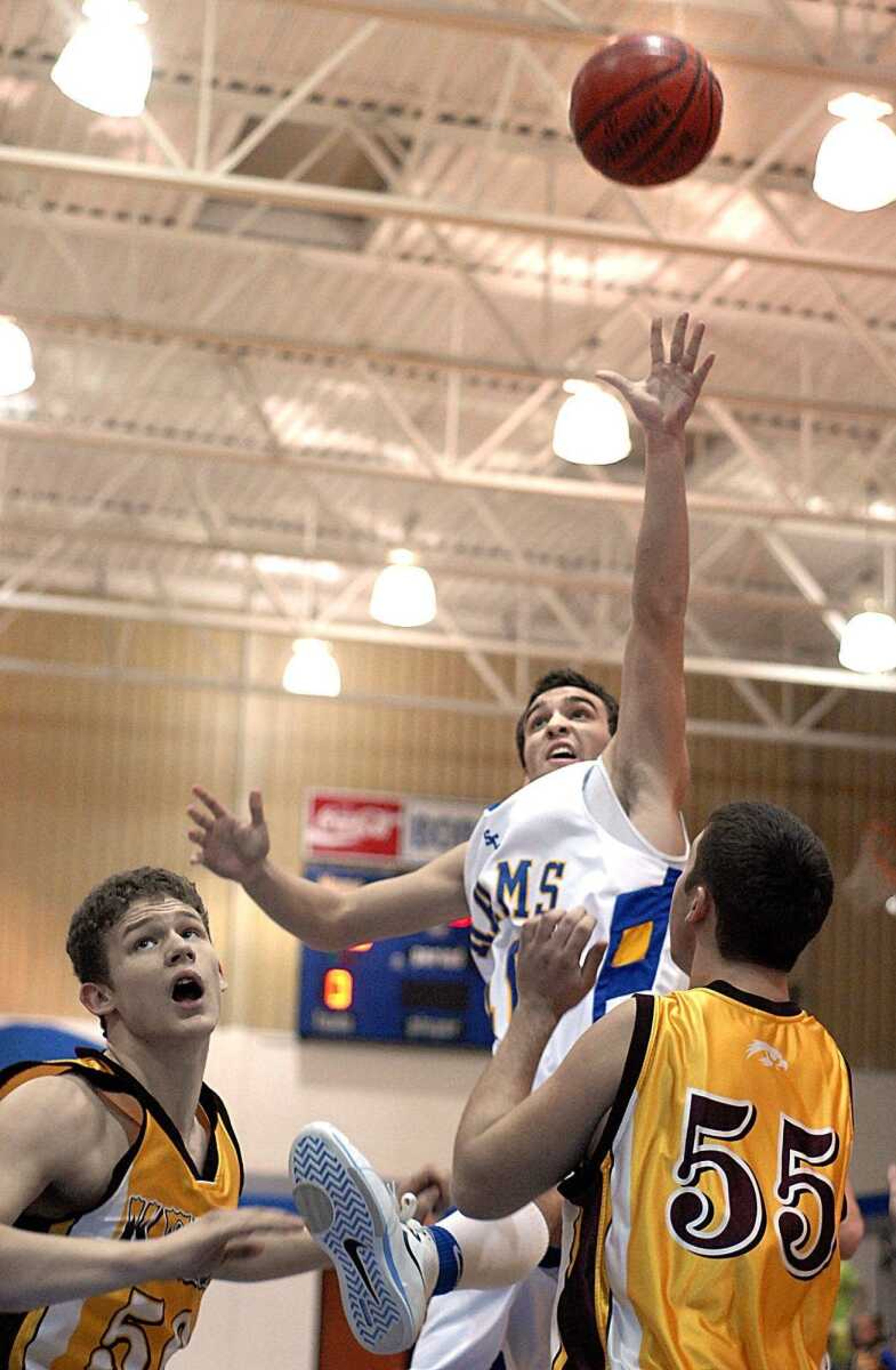 Scott City's Jay Simmons sank the first basket of the game over Kelly's Josh Rodgers and Eric Turley during their semifinal game Thursday night at the Scott-Mississippi Conference tournament game at Delta High School. (Aaron Eisenhauer)