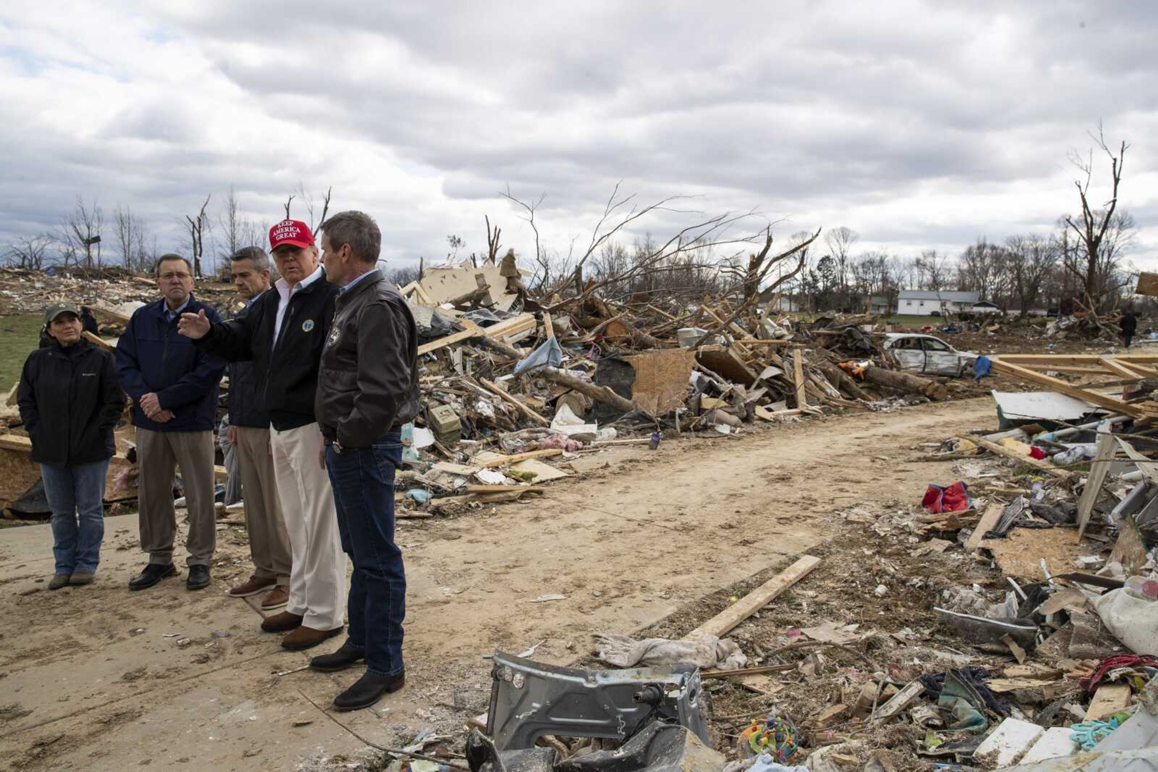 President Donald Trump, center, accompanied by, from left, Tennessee first lady Maria Lee, Putnam County Mayor Randy Porter, Cookeville Mayor Ricky Shelton and Gov. Bill Lee, R-Tenn., tour damage from a recent tornado Friday in Cookeville, Tennessee.