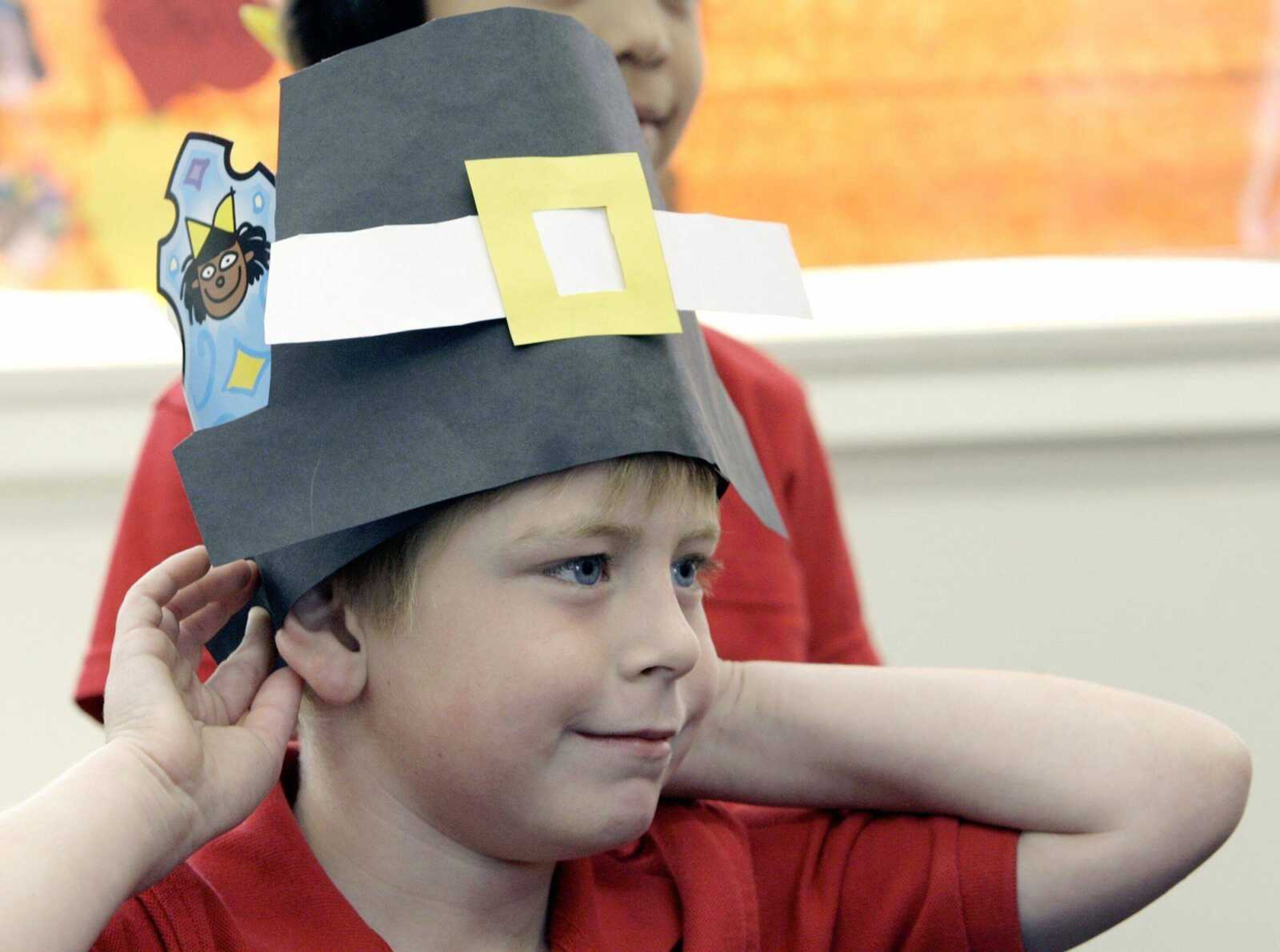 Connor Apel, 6, adjusted his paper Pilgrim hat for the Thanksgiving play put on by his class at Kettering Elementary School in Long Beach, Calif. (NICK UT ~ Associated Press)