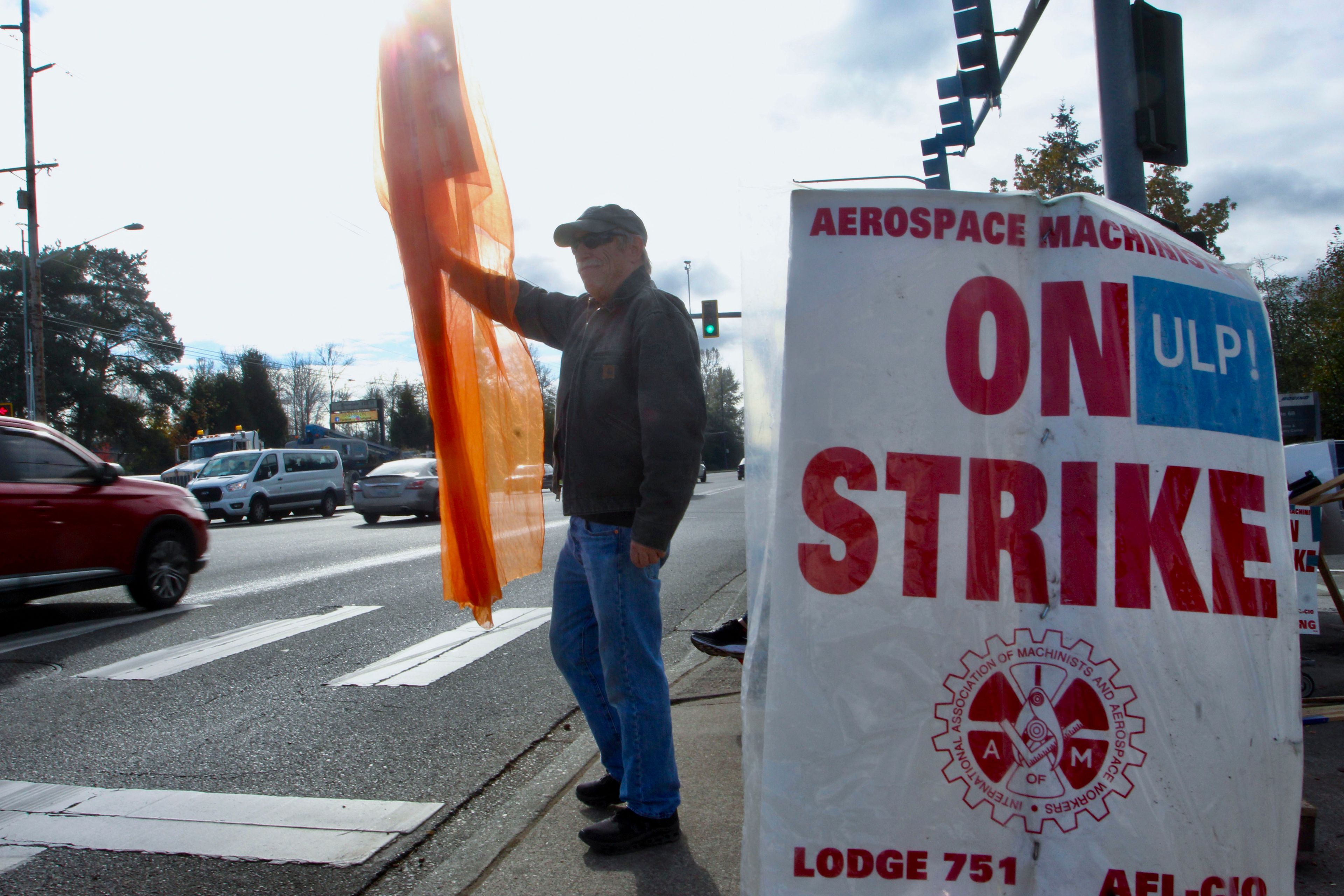 Union machinist Terry Muriekes waves a Halloween-decorated strike sign by Boeing's Everett, Wash., factory on Tuesday, Oct. 22, 2024. (AP Photo/Manuel Valdes)