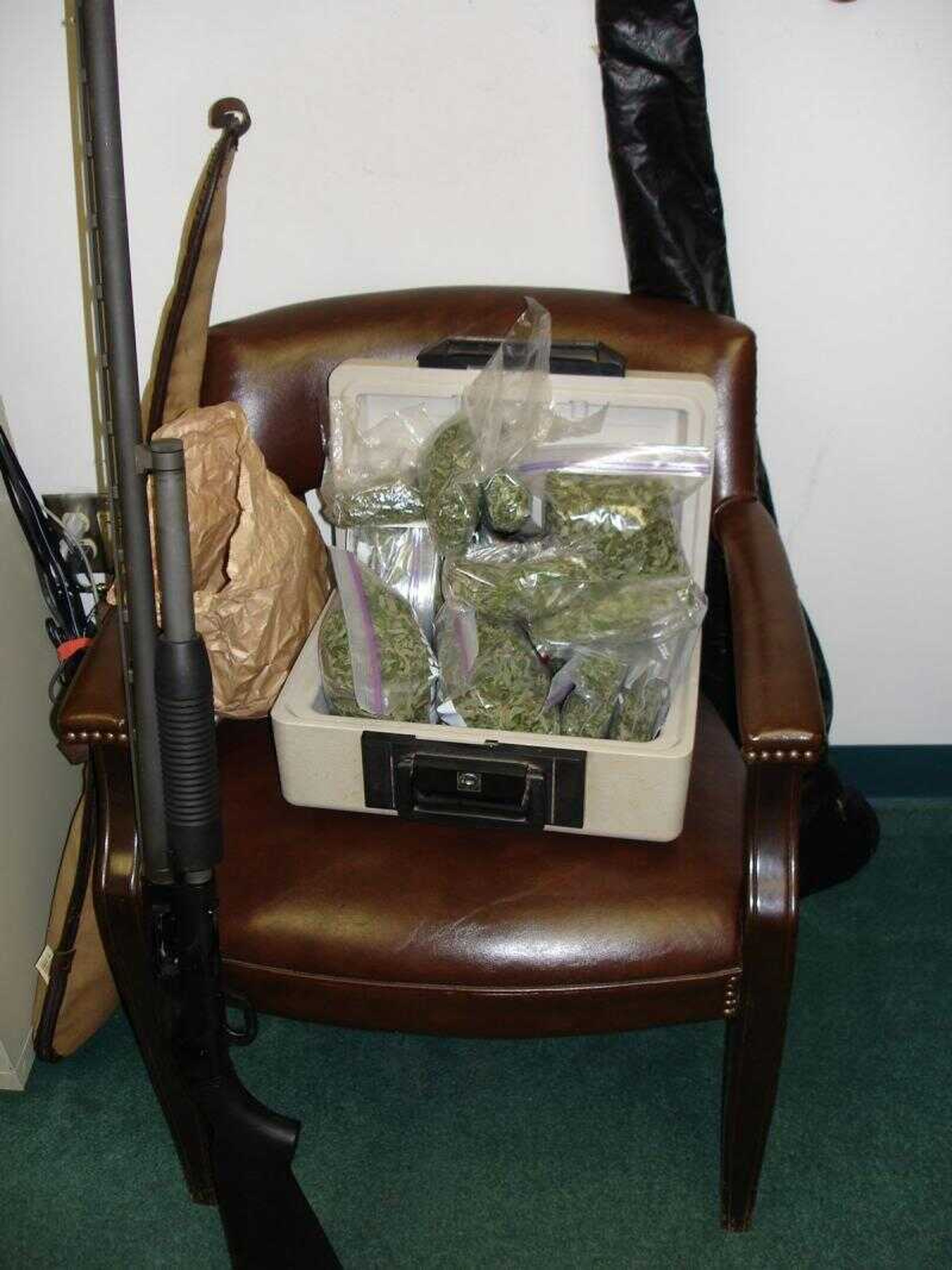 This photographed submitted by the Scott County Sheriff's Department shows some of the items, including a shotgun and baggies of marijuana police said were taken from a house in Morley, Mo. Two suspects were charged following a domestic dispute. (Submitted photo)