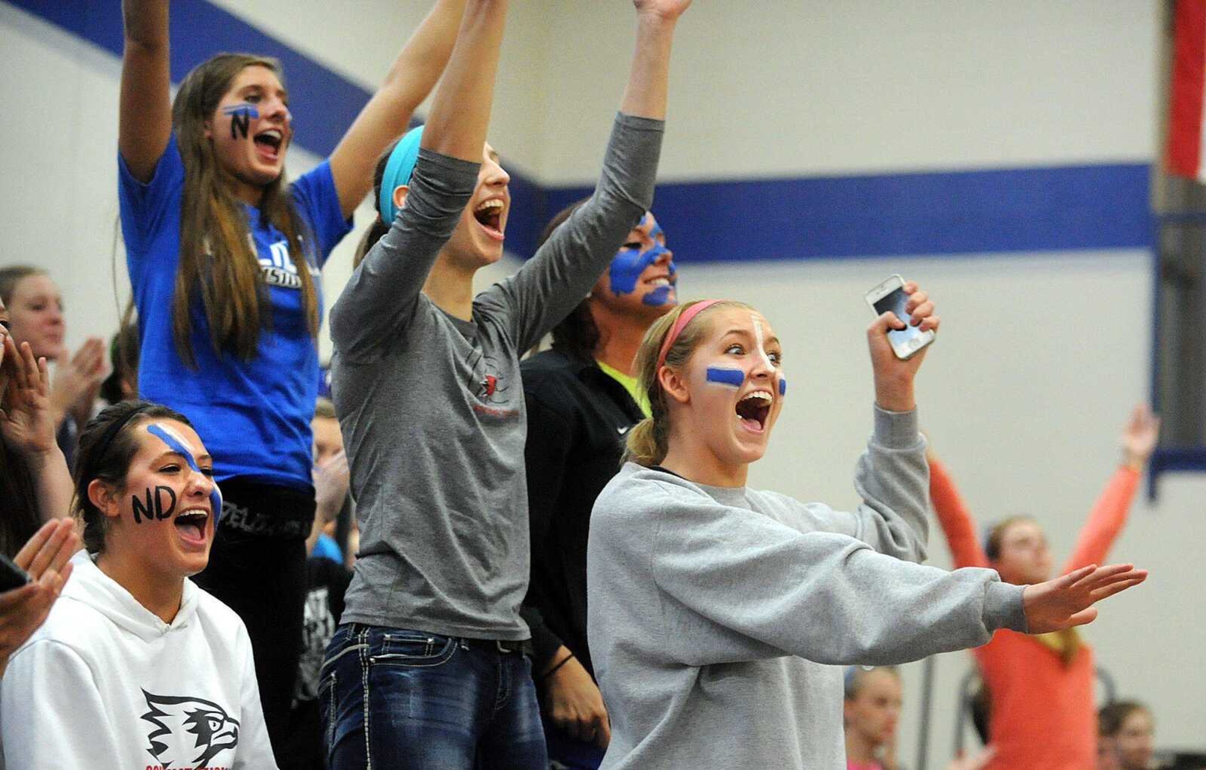 Notre Dame fans cheer in the stands as the Bulldogs win the second set against Duchesne.