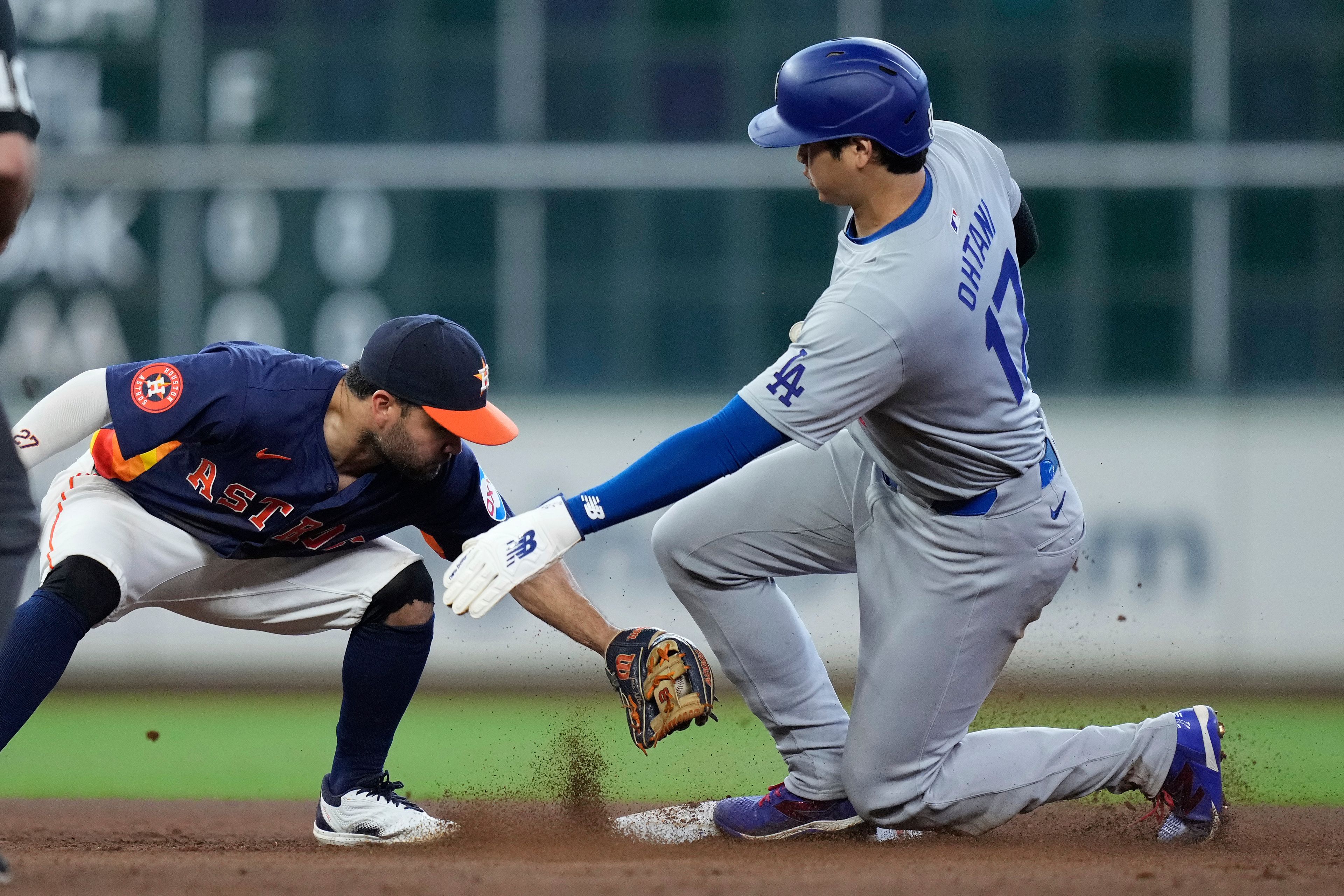 Houston Astros second baseman Jose Altuve, left, misses a tag as Los Angeles Dodgers designated hitter Shohei Ohtani (17) steals second during the ninth inning of a baseball game Sunday, July 28, 2024, in Houston. (AP Photo/Kevin M. Cox)