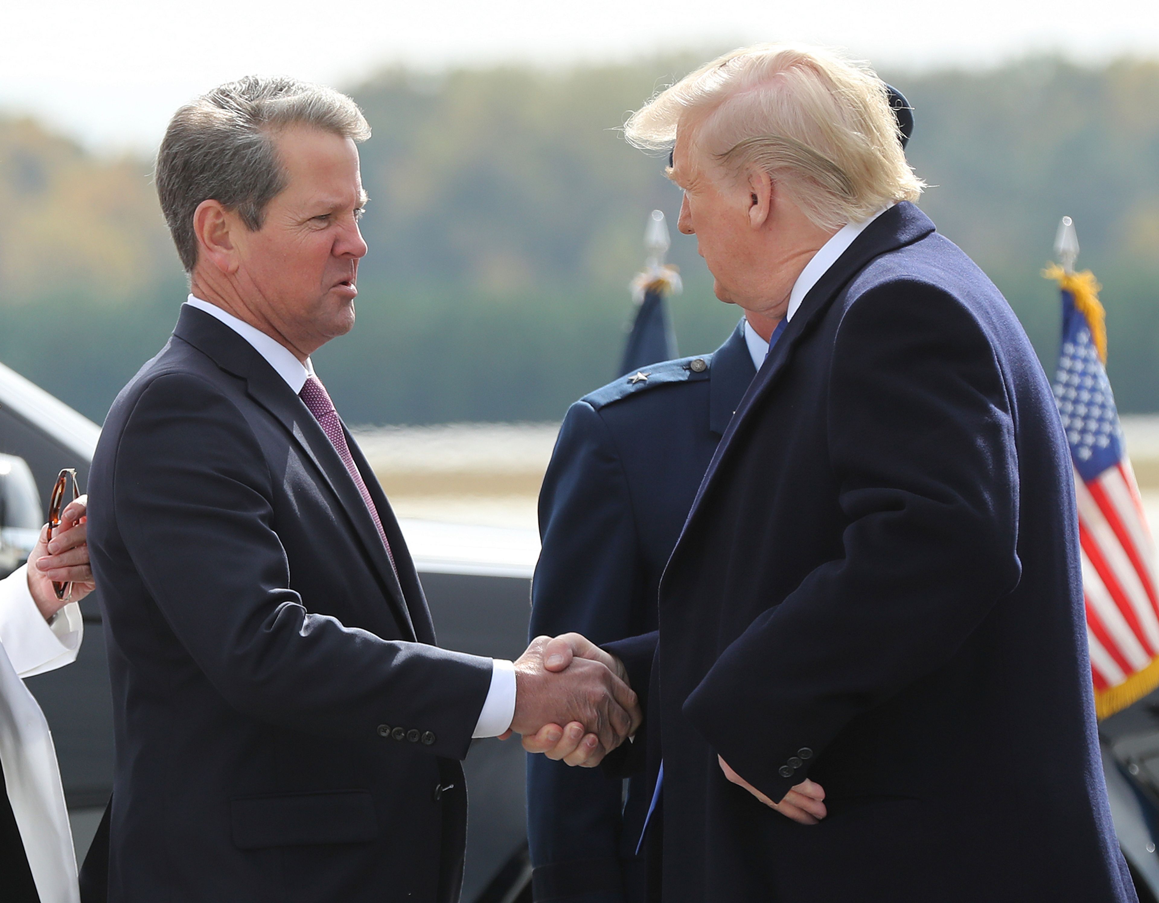 FILE - Georgia Gov. Brian Kemp, left, greets President Donald Trump as he arrives at Dobbins Air Reserve Base, Nov. 8, 2019, in Marietta, Ga. (Curtis Compton/Atlanta Journal-Constitution via AP, File)