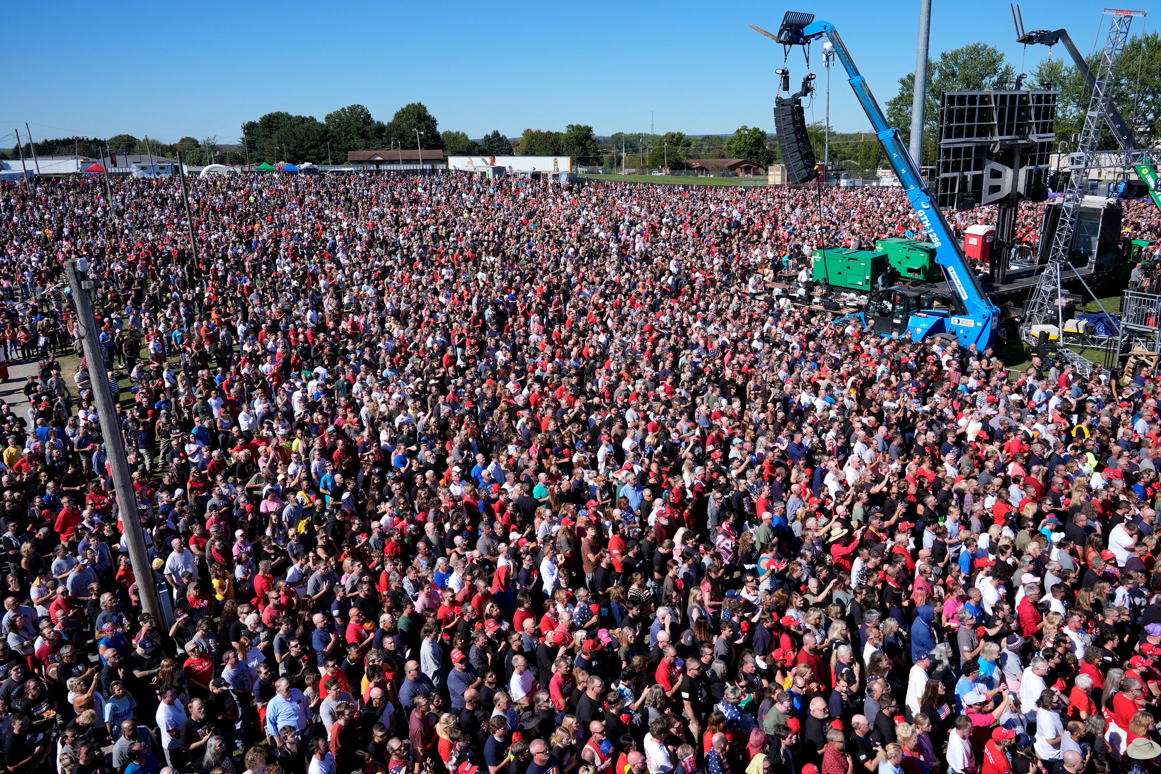 Attendees listen during the singing of the national anthem before Republican presidential nominee former President Donald Trump arrives to speak at a campaign event at the Butler Farm Show, Saturday, Oct. 5, 2024, in Butler, Pa. (AP Photo/Alex Brandon)