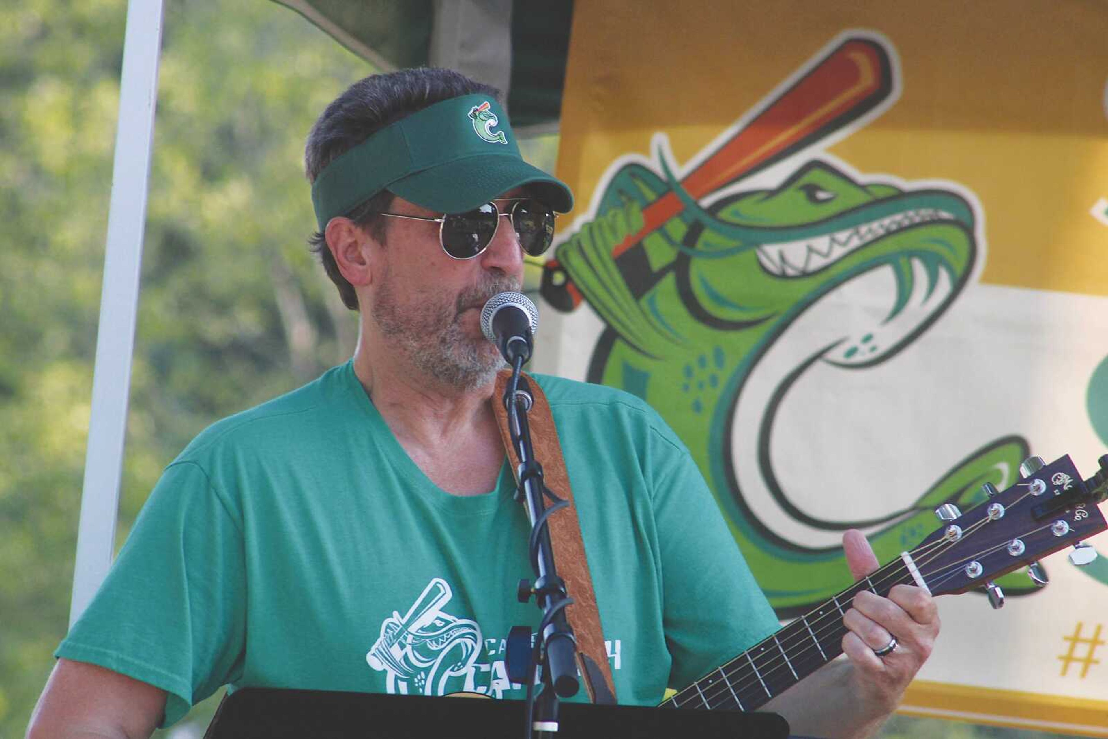  Mehner plays accoustic guitar with the band Group Therapy in summer 2021 at Capaha Field.  
