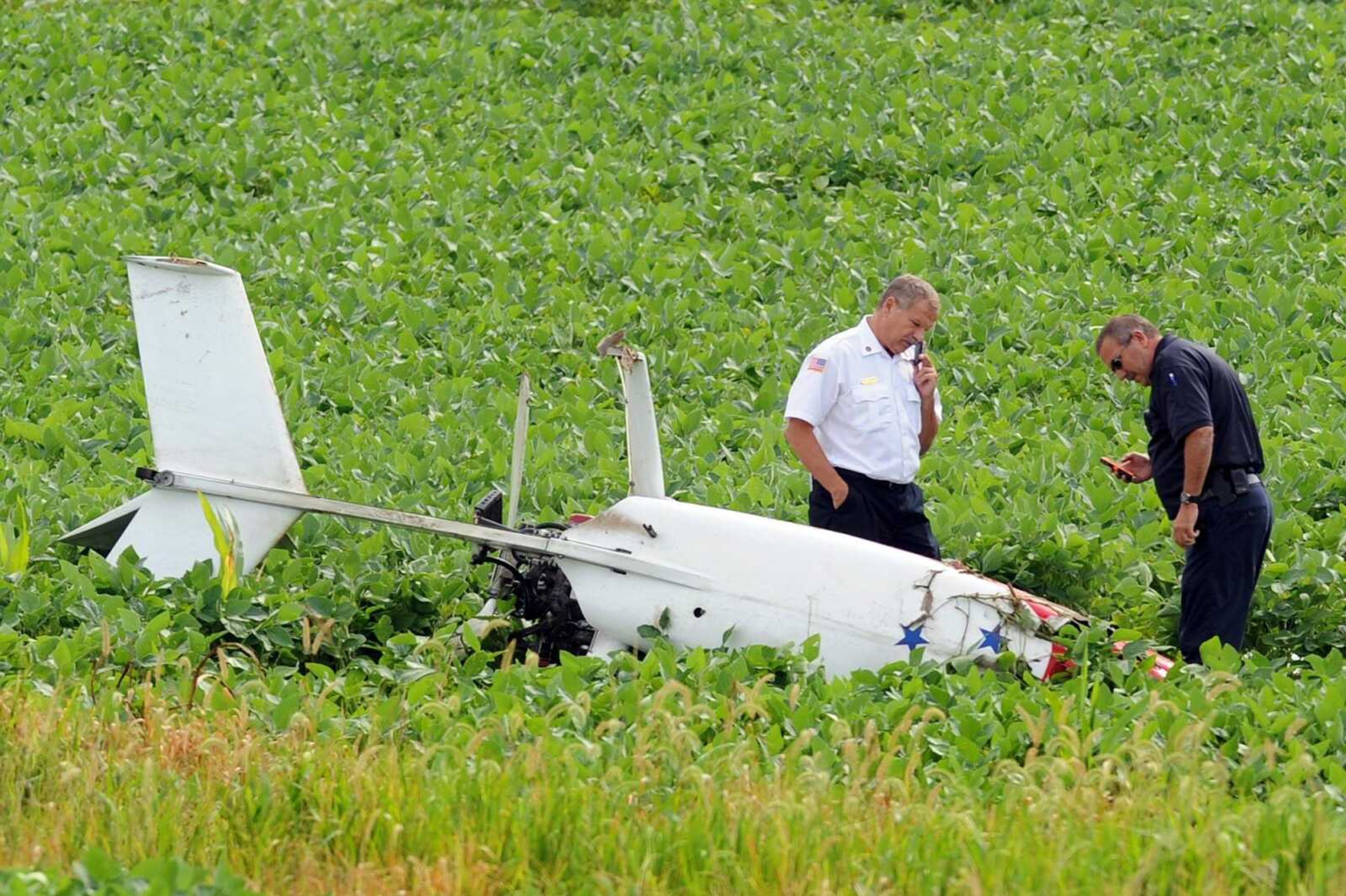 First responders work the scene of a gyrocopter crash off of Cape Girardeau County Road 203, Thursday, July 17, 2014. The gyrocopter crashed in a field of soybeans. One person, the pilot, was on board at the time, and was taken by ambulance from the scene to an area hospital. (Laura Simon)