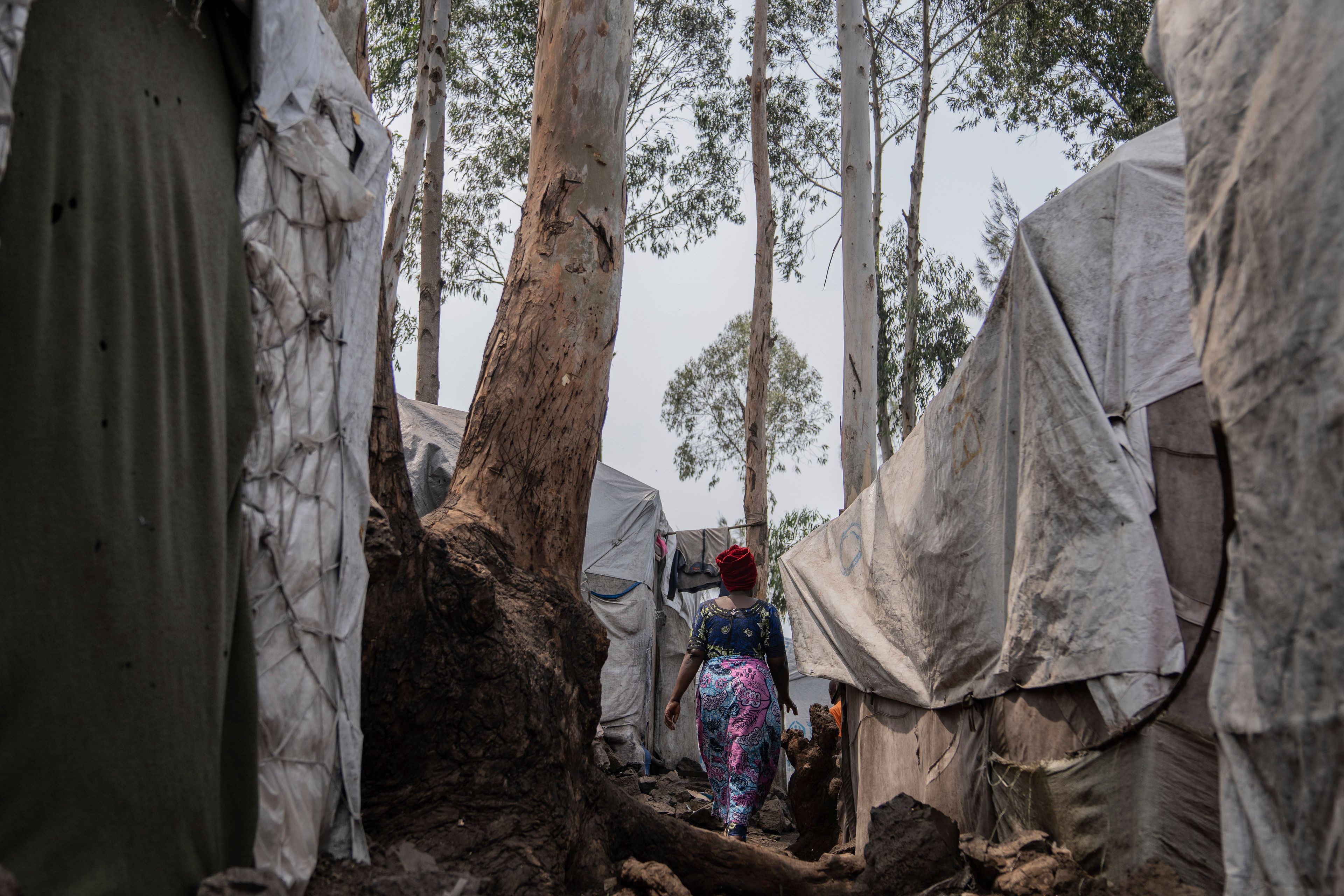 Nelly Shukuru, 51, who had planned hanging herself, walks in the Lushagala camp in Goma, Democratic Republic of the Congo, Tuesday, Aug. 27, 2024. (AP Photo/Moses Sawasawa)