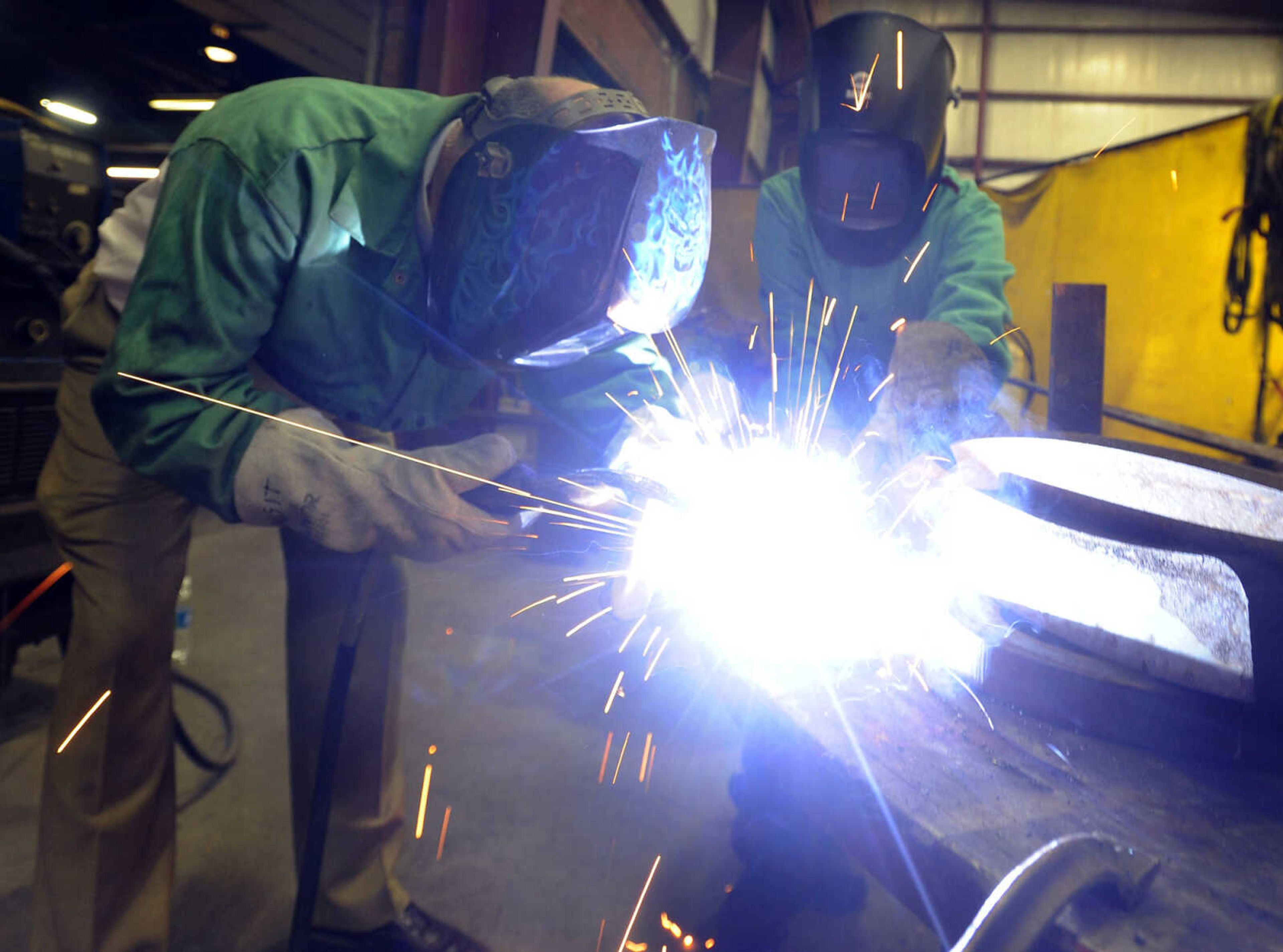 FRED LYNCH ~ flynch@semissourian.com
David Hutson takes a turn at welding on the collaborative steel sculpture, with assistance from Jessica Lambert, Thursday, April 20, 2017 during ARTrageous at Erlbacher Gear and Machine Works in Cape Girardeau.