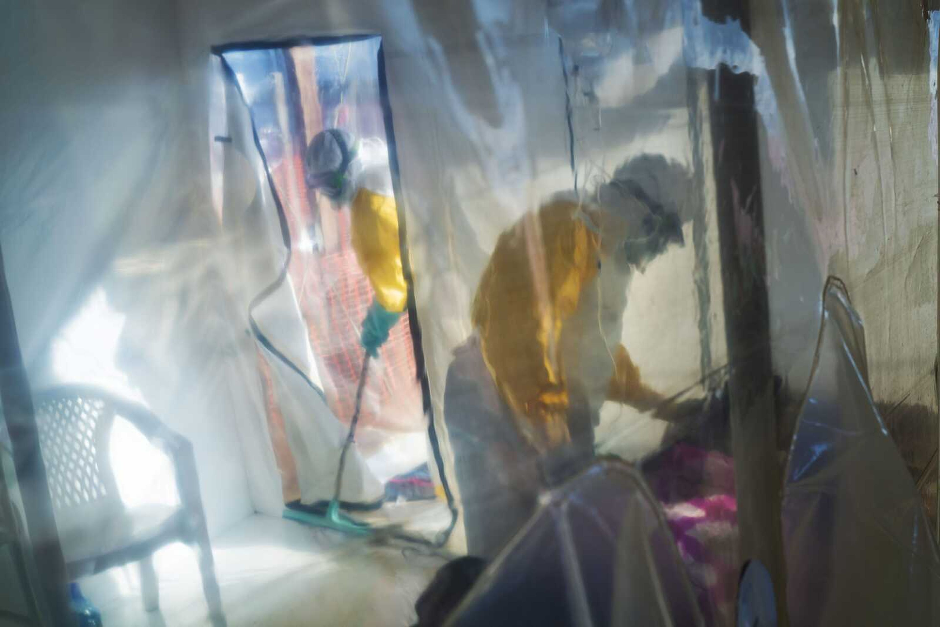 Health workers wearing protective suits tend to to an Ebola victim kept in an isolation cube in Beni, Congo. The Congolese health ministry is confirming the country's first Ebola case in the provincial capital of 2 million, Goma.