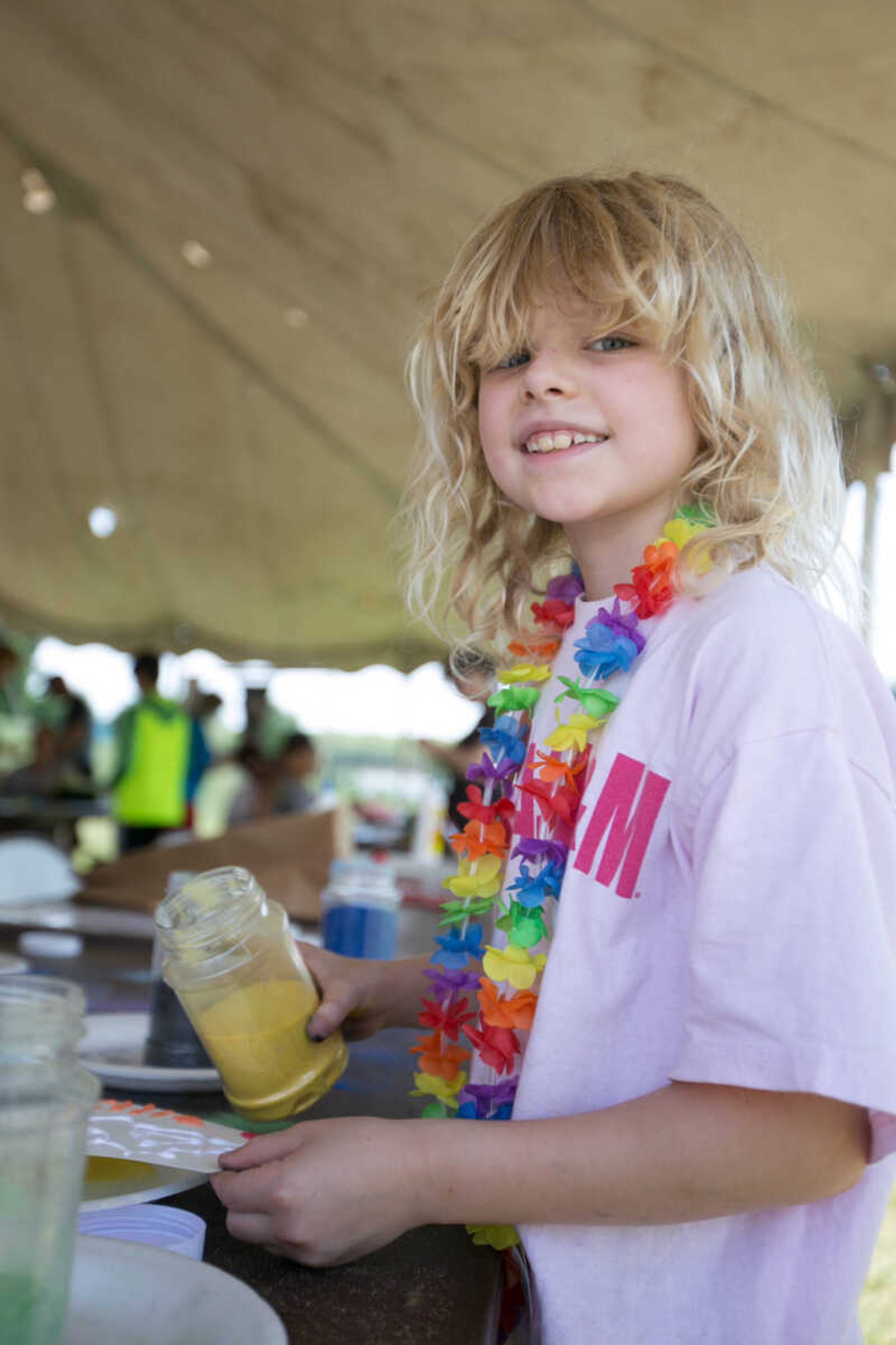 GLENN LANDBERG ~ glandberg@semissourian.com

Ellie Douglass sprinkles colored sand while creating art Saturday, June 18, 2016 at the River Campus Summer Arts Festival.