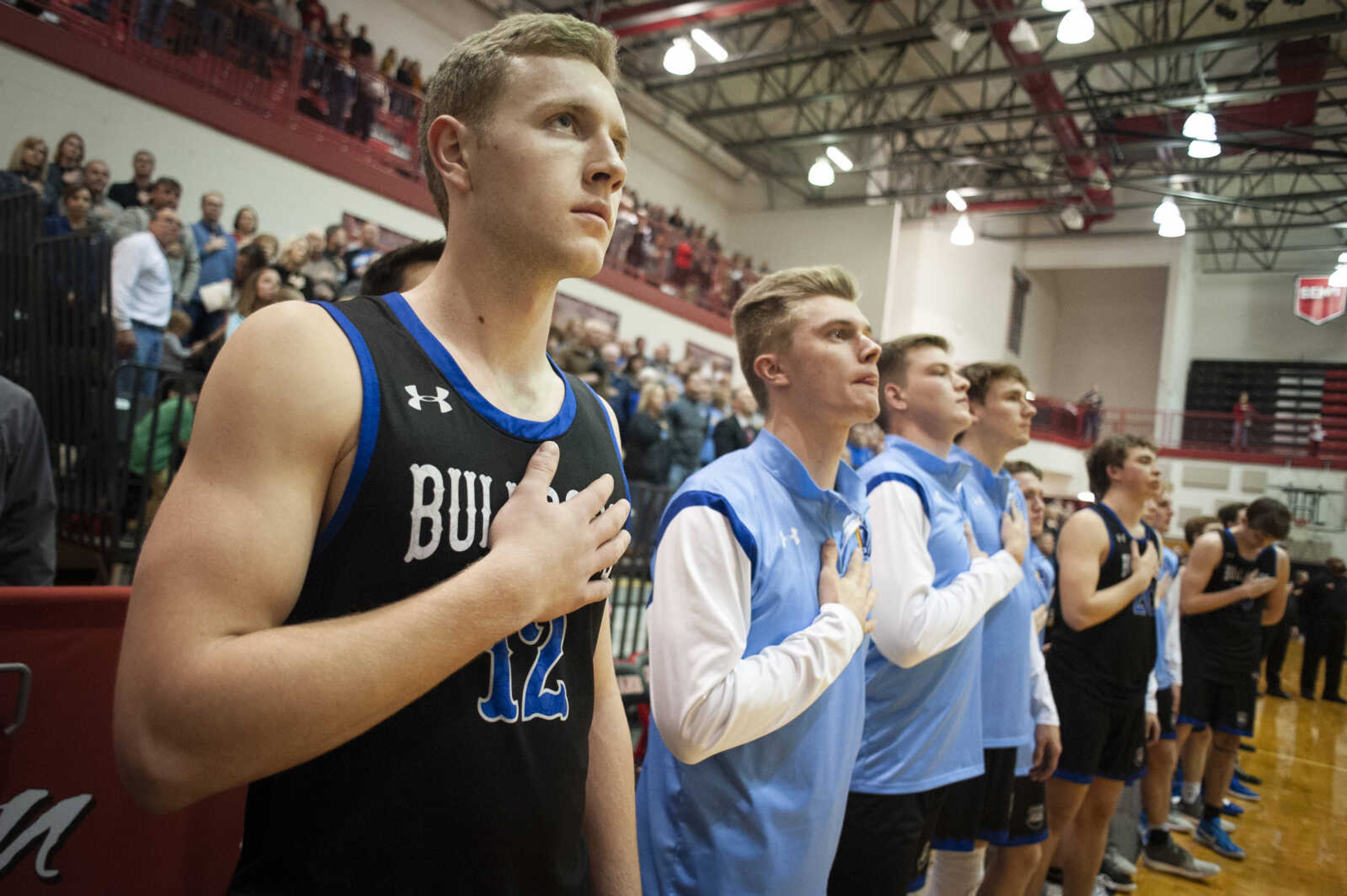 Notre Dame's Carter Dame (12) stands for the national anthem with other Bulldogs before the start of the team's 57-42 victory over the Jackson Fighting Indians on Friday, Jan. 25, 2019, at Jackson High School.