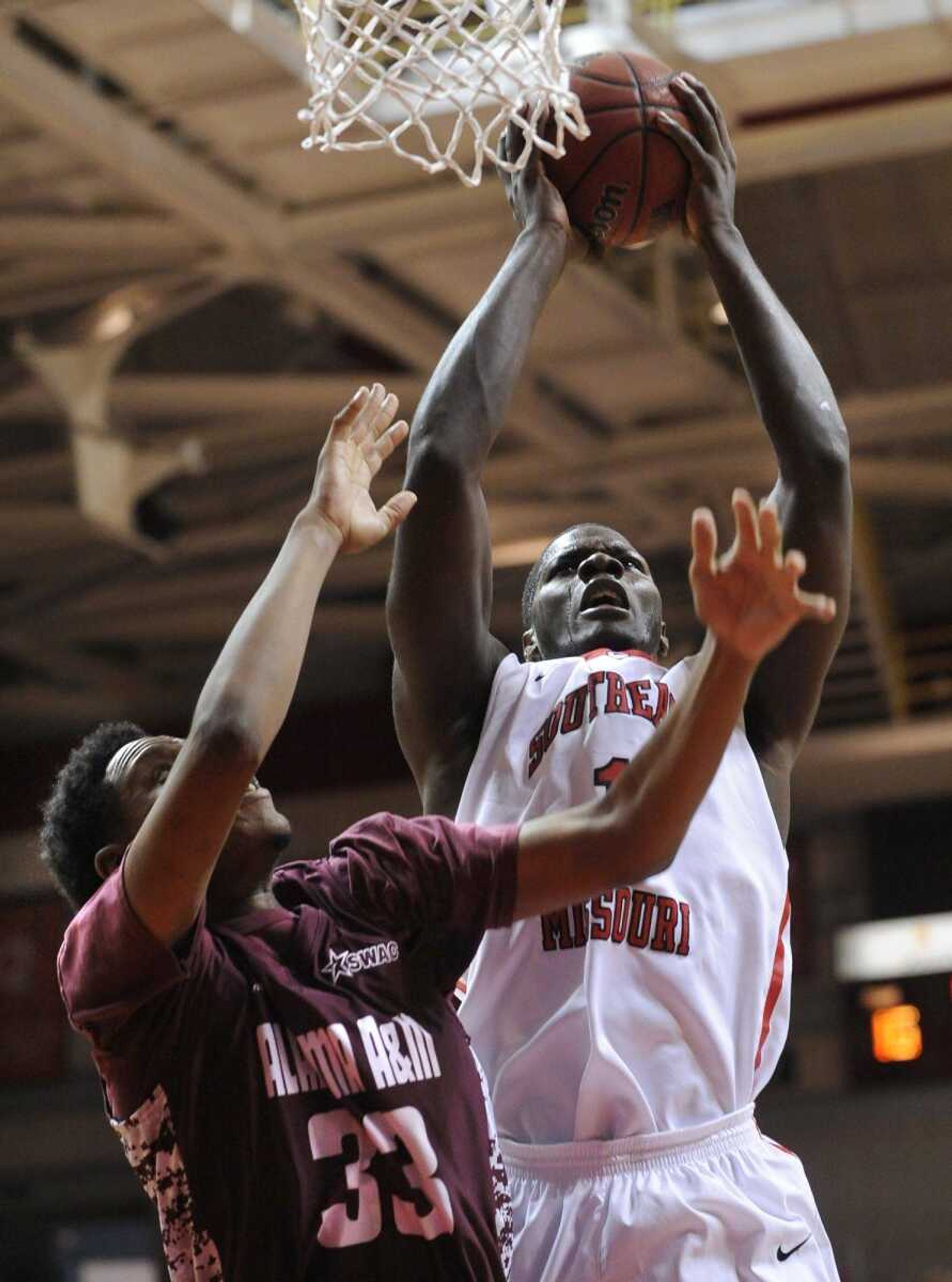 Southeast Missouri State's Nino Johnson grabs a rebound away from Alabama A&M's Baryn Houston during the first half Saturday, Nov. 29, 2014 at the Show Me Center. (Fred Lynch)