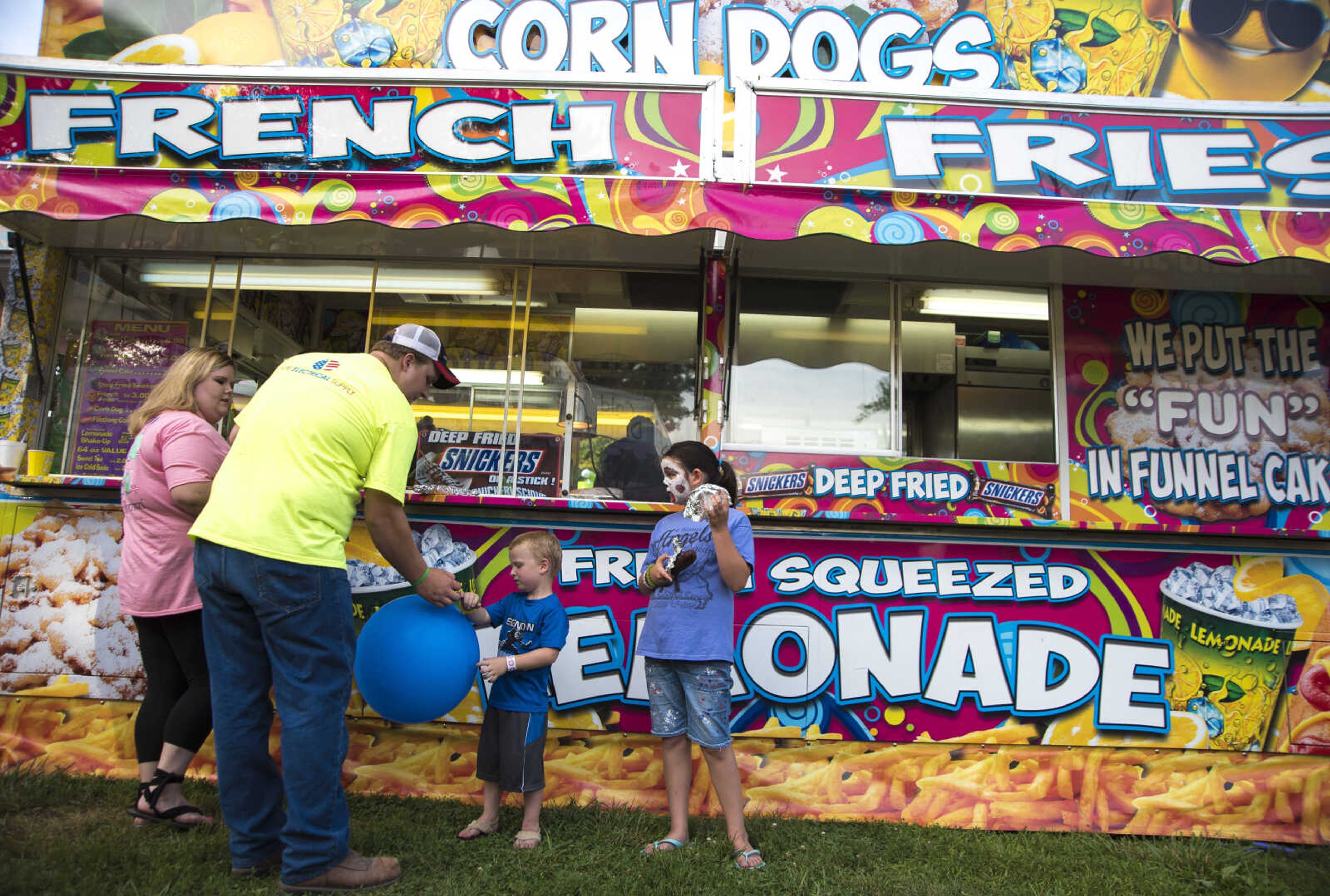 People wait in line for food during the 41st annual Mid-Summer Festival Saturday, June 17, 2017 at Scott City Park.