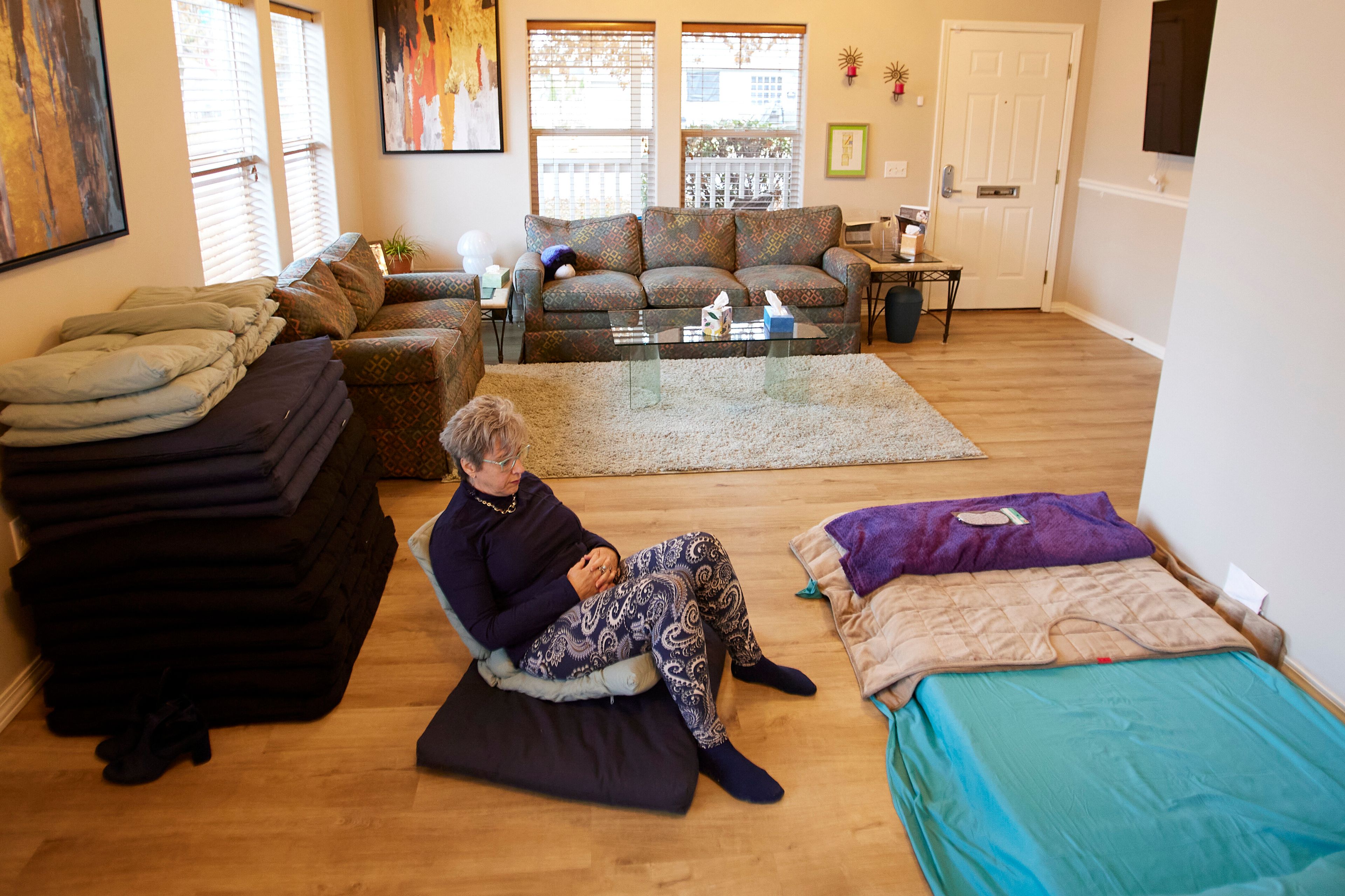 MJ Wilt, a licensed psilocybin facilitator and the owner of a licensed psilocybin service center, sits in a room setup for groups at her facility in Gresham, Ore., Monday, Nov. 18, 2024. (AP Photo/Craig Mitchelldyer)