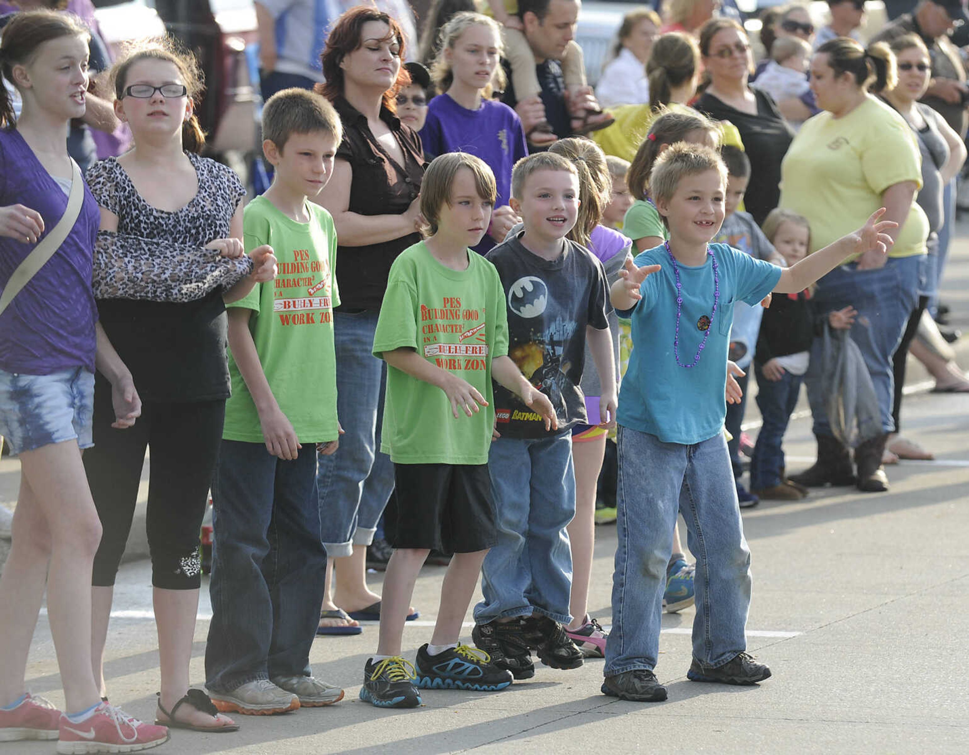 Children scramble for candy during the Perryville Mayfest Parade Friday, May 10, in Perryville, Mo. This year's Mayfest theme is Peace, Love, Perryville Mayfest.