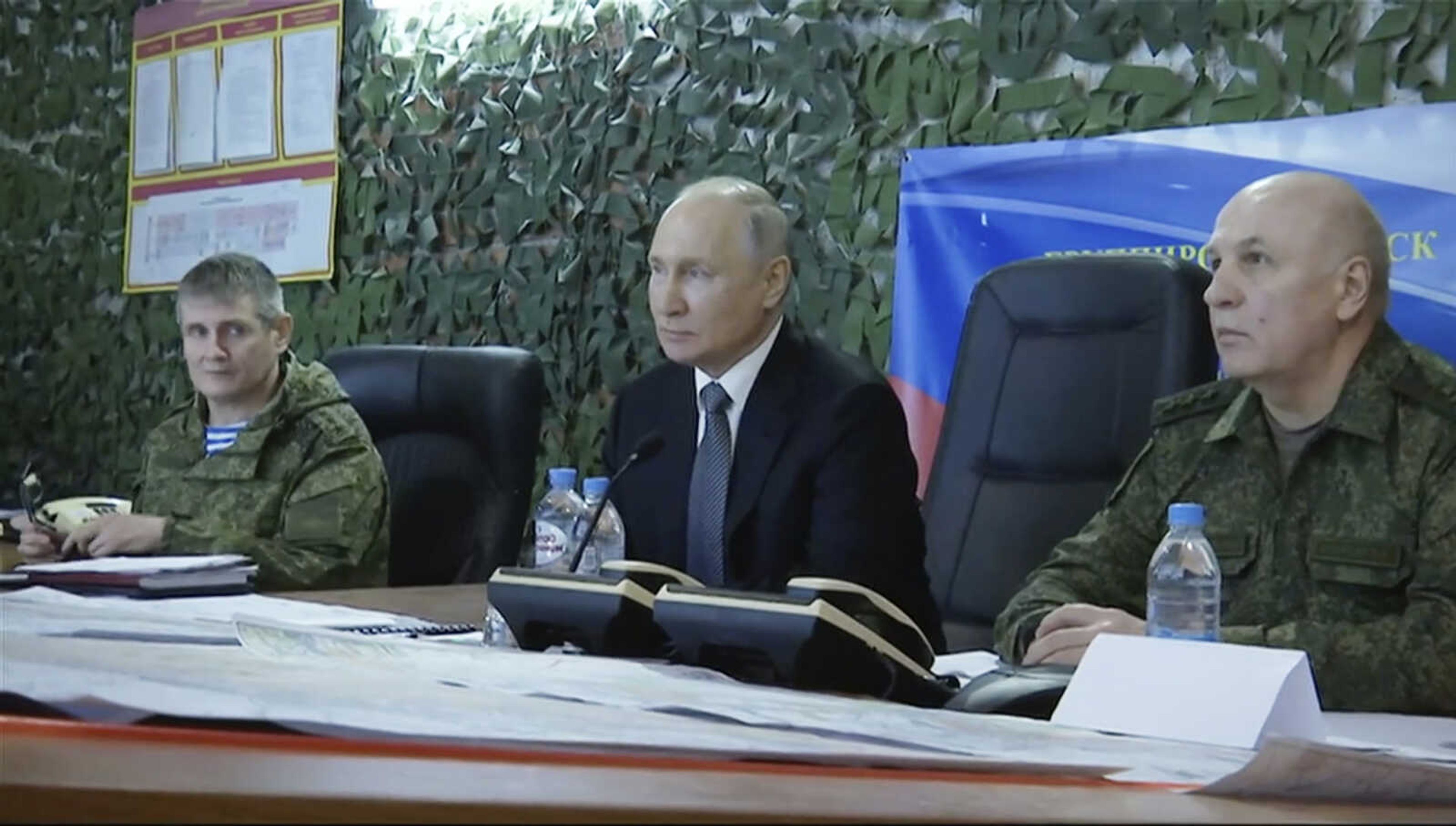 In this photo taken from video released by Russian TV pool Tuesday, Russian President Vladimir Putin, center, attends a meeting with commander of the grouping of troops "Dnepr" Col. Gen. Oleg Makarevich, right, and Commander of the Airborne Forces Col. Gen. Mikhail Teplinskiy at the headquarters of the group of troops "Dnepr" in the Kherson direction, at an undisclosed location, Ukraine.