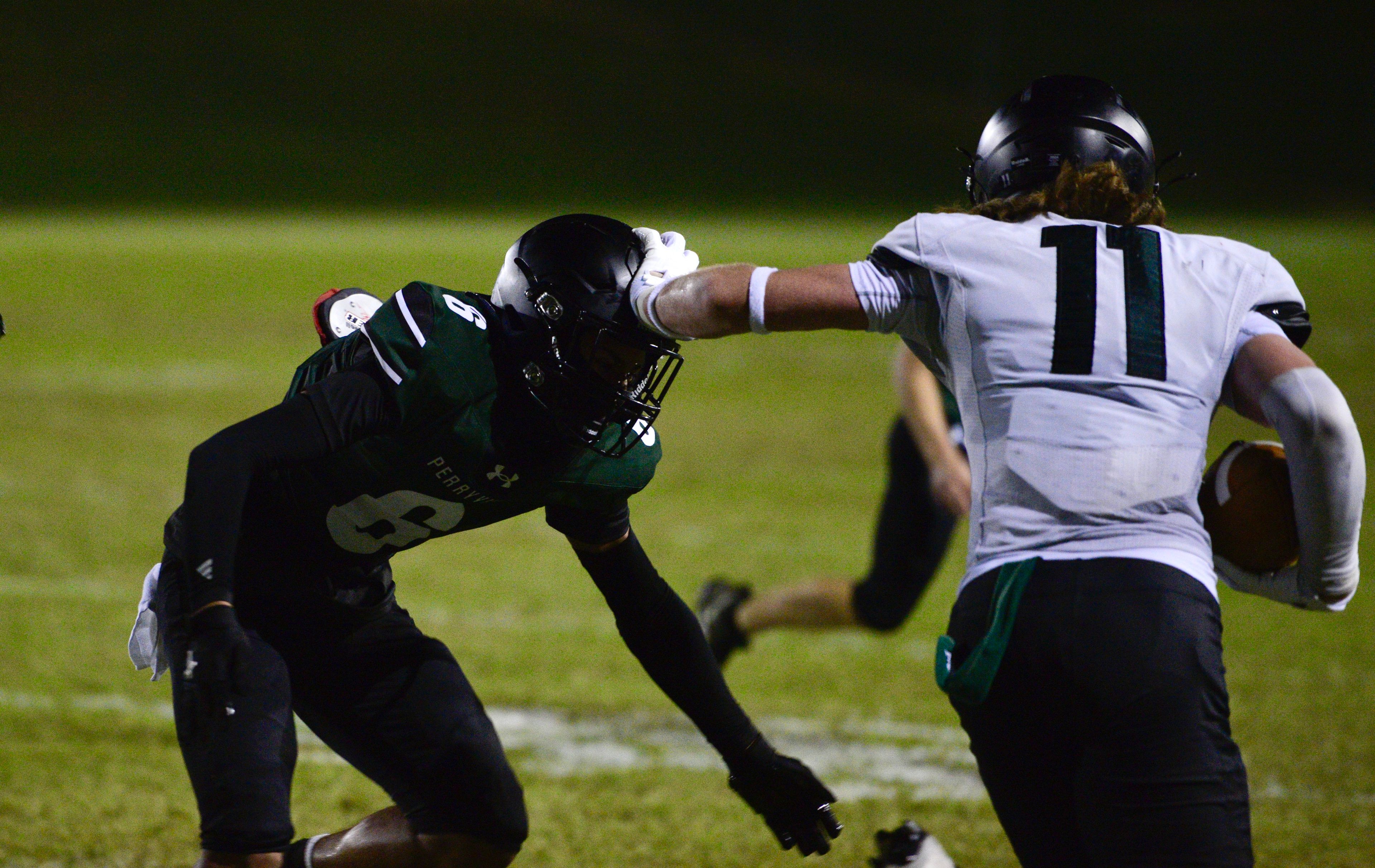 Perryville’s Dominic Seiler stiff-arms Gavin Hemmann during the Midnight Game on Saturday, Aug. 17, at Perryville High School.