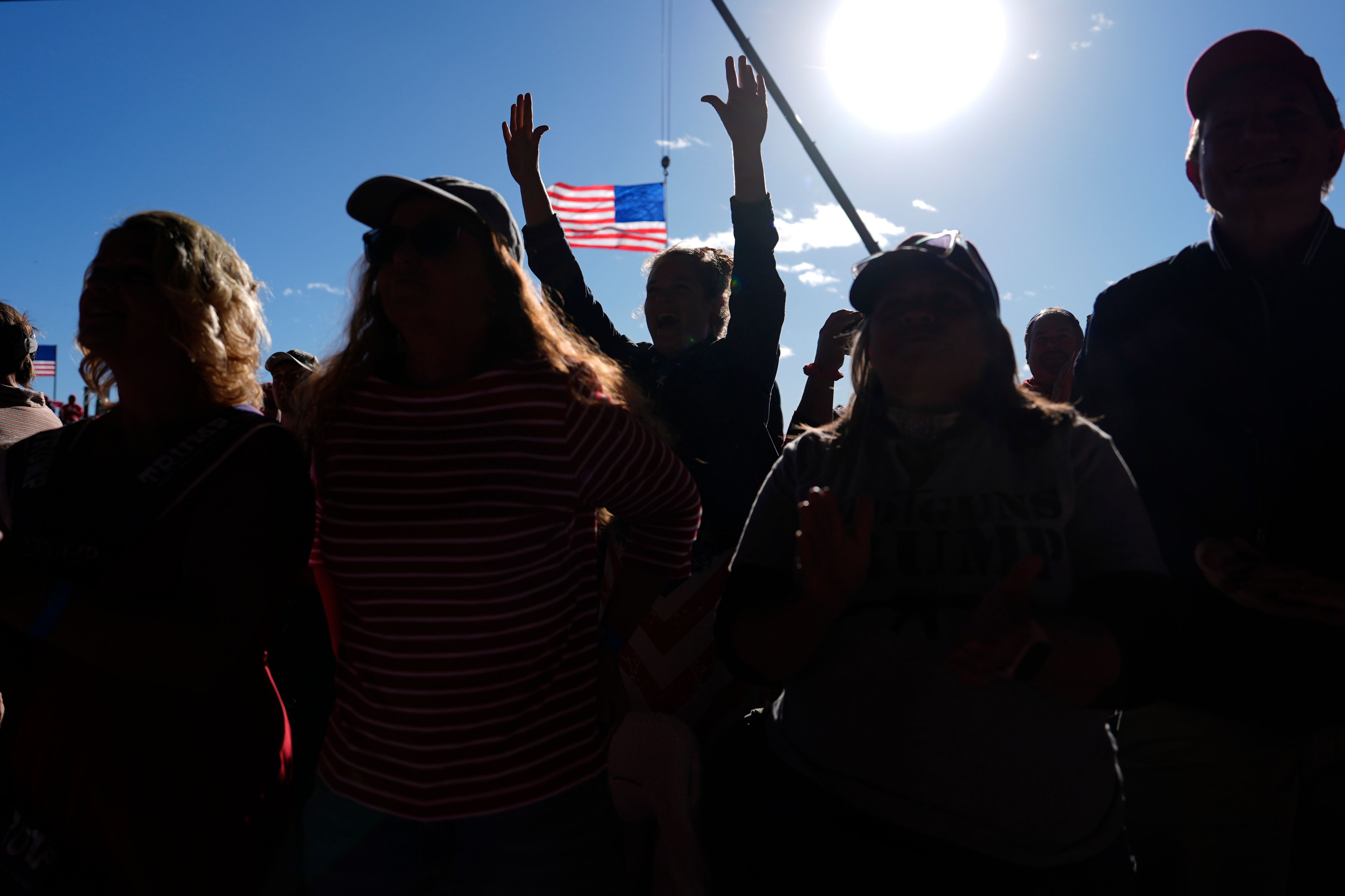 Attendees listen as Republican presidential nominee former President Donald Trump speaks during a campaign rally at Dodge County Airport, Sunday, Oct. 6, 2024, in Juneau, Wis. (AP Photo/Julia Demaree Nikhinson)