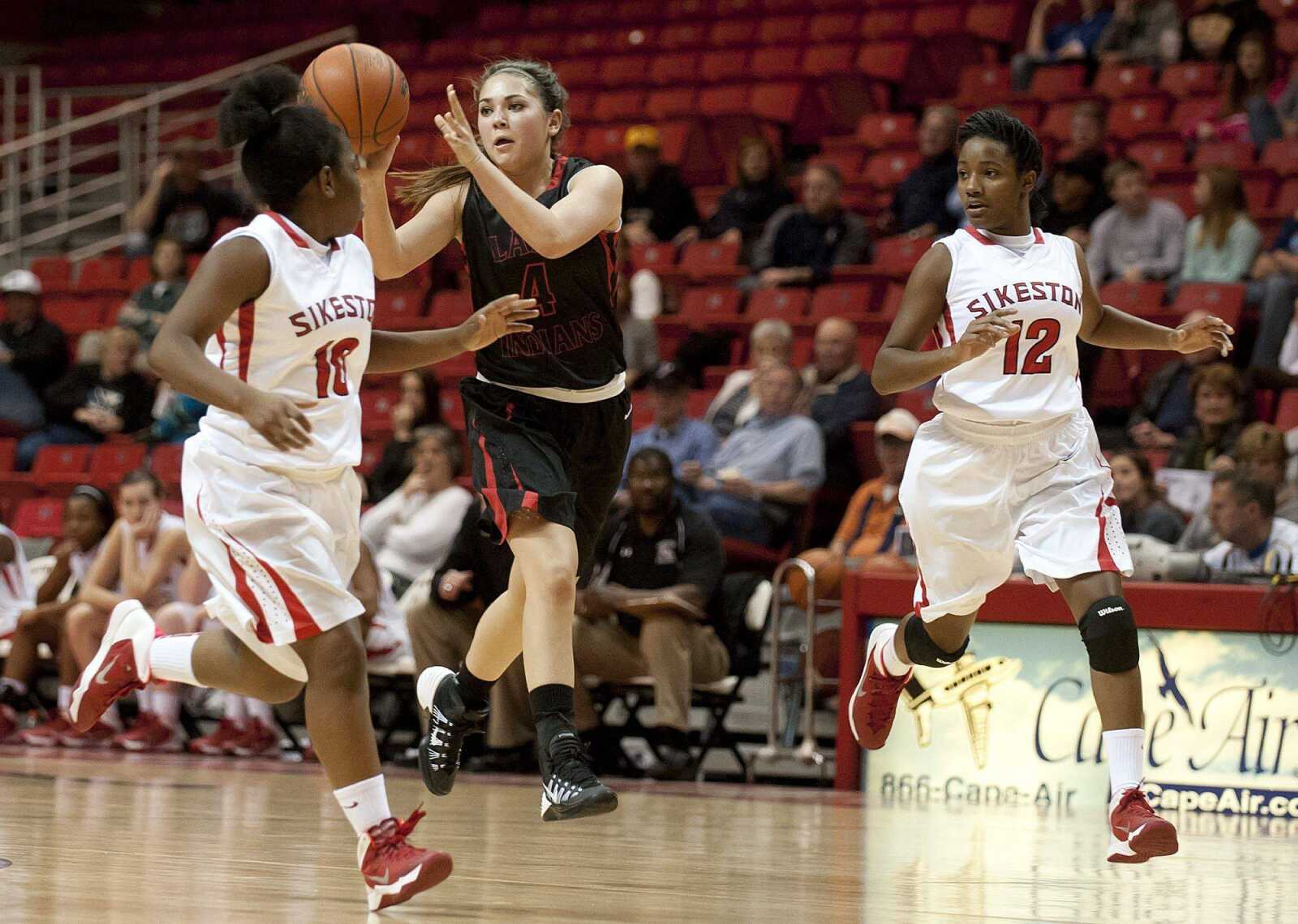 Jackson junior Rachel CritesCQ makes a pass from between Sikeston&#180;s Dominique RoachCQ, left, and Tyra BonnerCQ in the first half of the Indians' win over the Bulldogs in the third place game of the Kelso Supply Holiday Classic Thursday, Dec. 19, at the Show Me Center. (Adam Vogler)