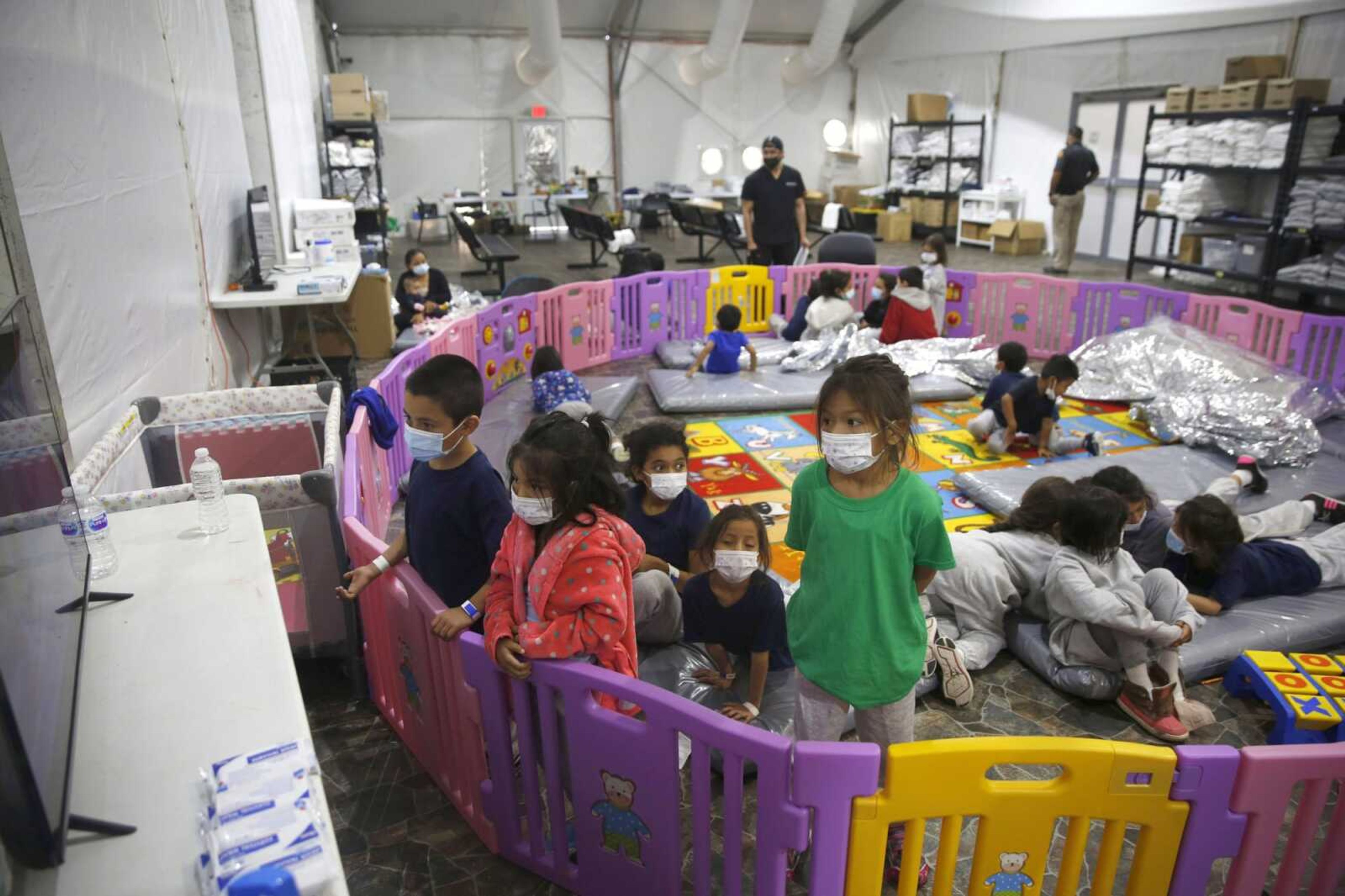 Young unaccompanied migrants, from ages 3 to 9, watch television inside a playpen at the U.S. Customs and Border Protection facility, the main detention center for unaccompanied children in the Rio Grande Valley, on March 30 in Donna, Texas.