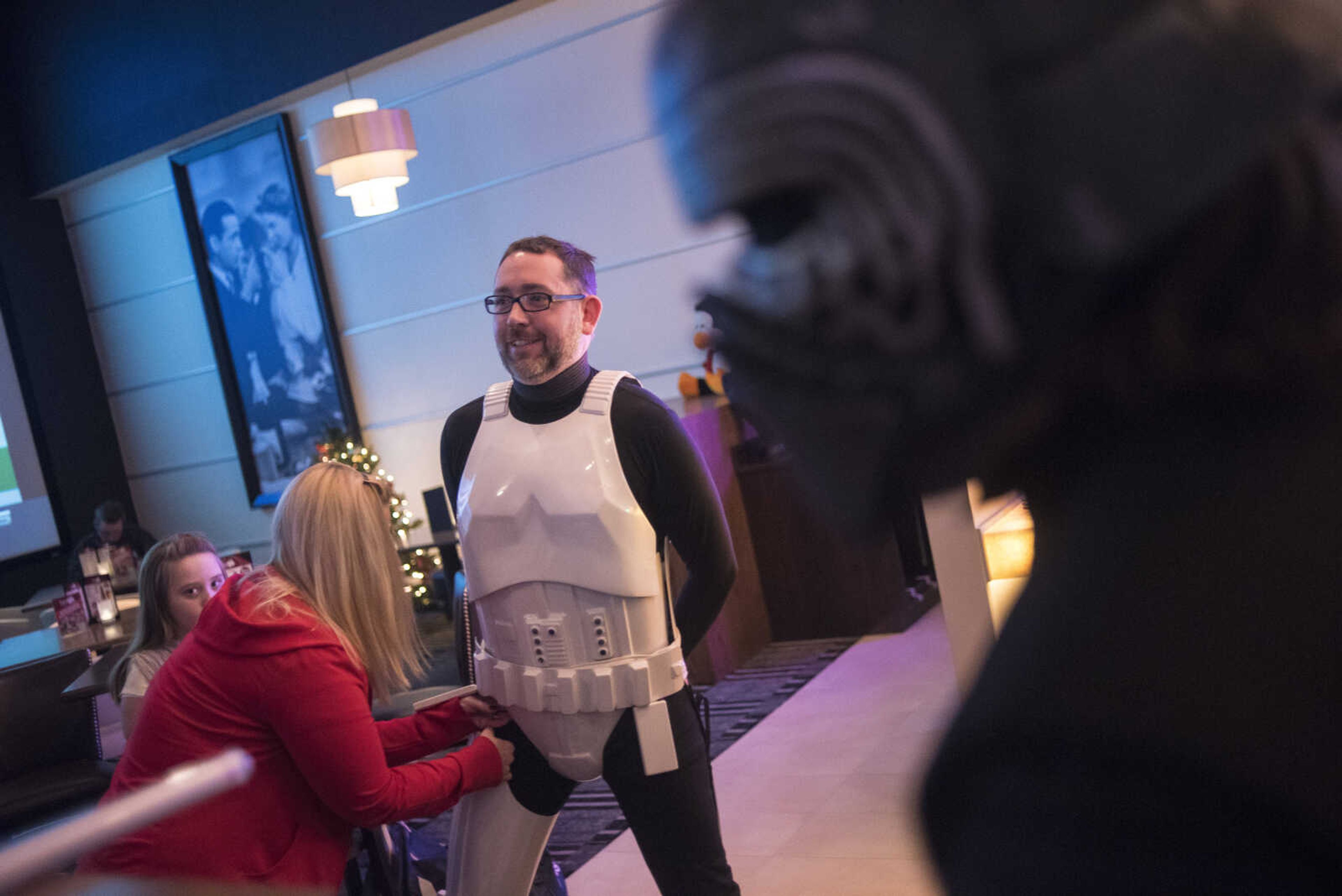 Yuri Rentfro has his wife Khristen Rentfro help him with his stormtrooper costume before the showing of Star Wars: The Last Jedi Thursday, Dec. 14, 2017 at Cape West Cinema in Cape Girardeau.