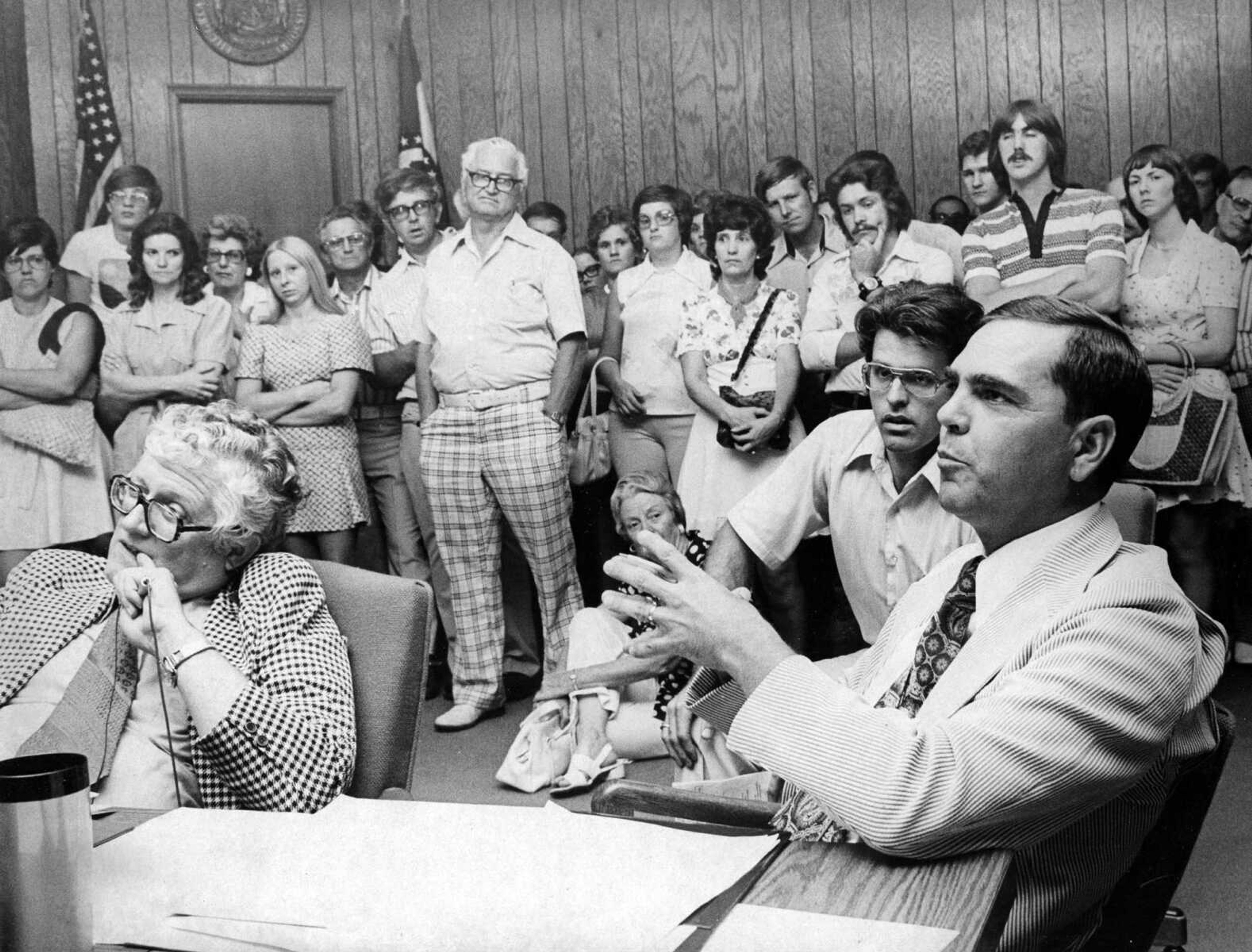 Published June 16, 1977.
About 350 persons were present to voice disapproval of a city zoning law, which would have established a C-X District in Cape Girardeau. The ordinance was designed to tighten the cityŐs stand against pornography. Here, Councilman Paul Stehr, seated at far right, responded to a comment from attorney Stephen N. Limbaugh, while City Manager W.G. Lawley and former city attorney Thomas M. Utterback looked on. In the background are some of the spectators who filled the council chambers to overflowing. (Phil Nash ~ Southeast Missourian archive)