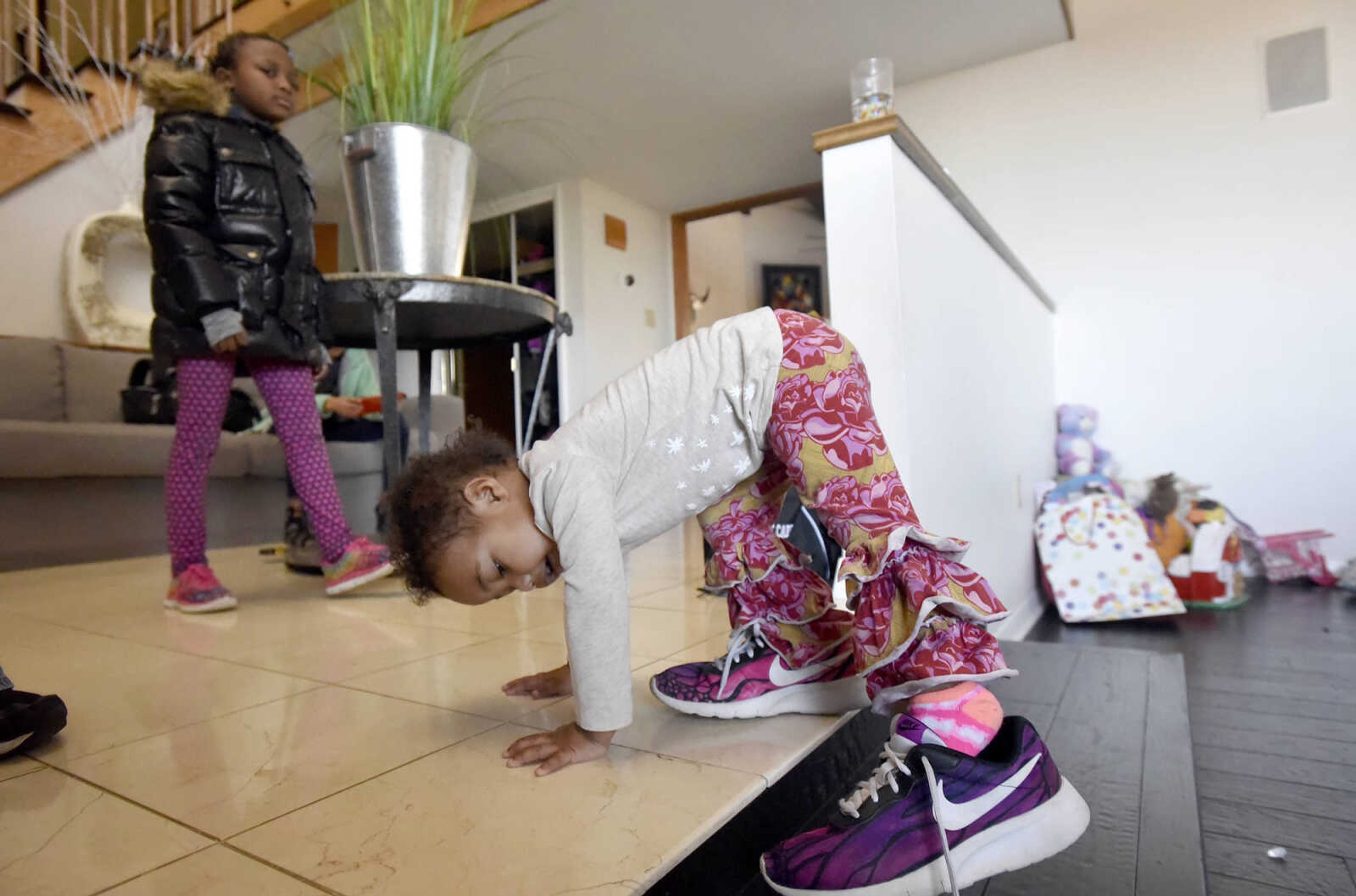 Lennyx Becking, 1, tries on her mother's shoes on Saturday, Jan. 28, 2017, at the Becking's Cape Girardeau home.